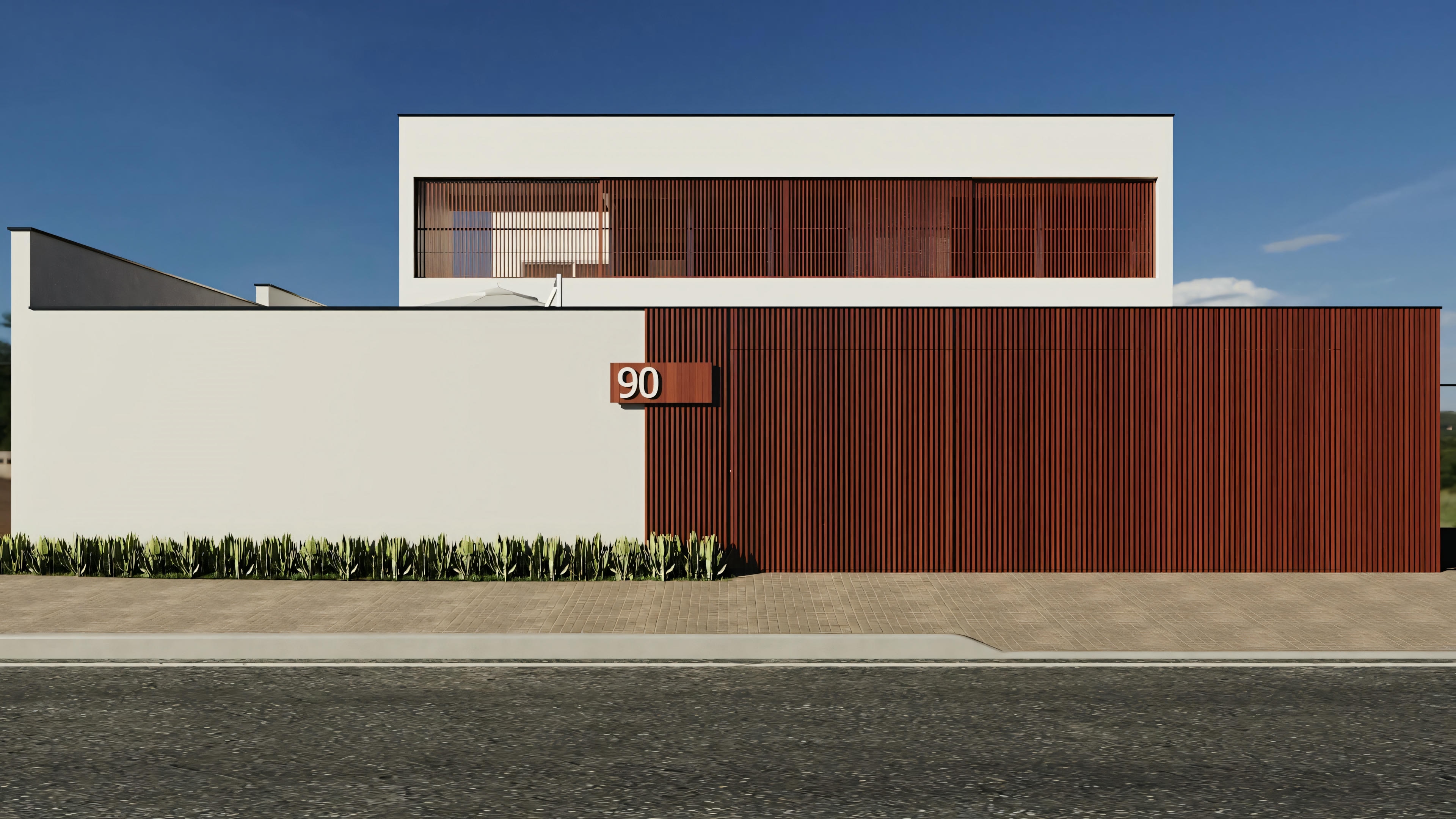Una casa moderna con techo plano, paredes blancas y paneles de madera, con un camino claro que lleva a la puerta principal.