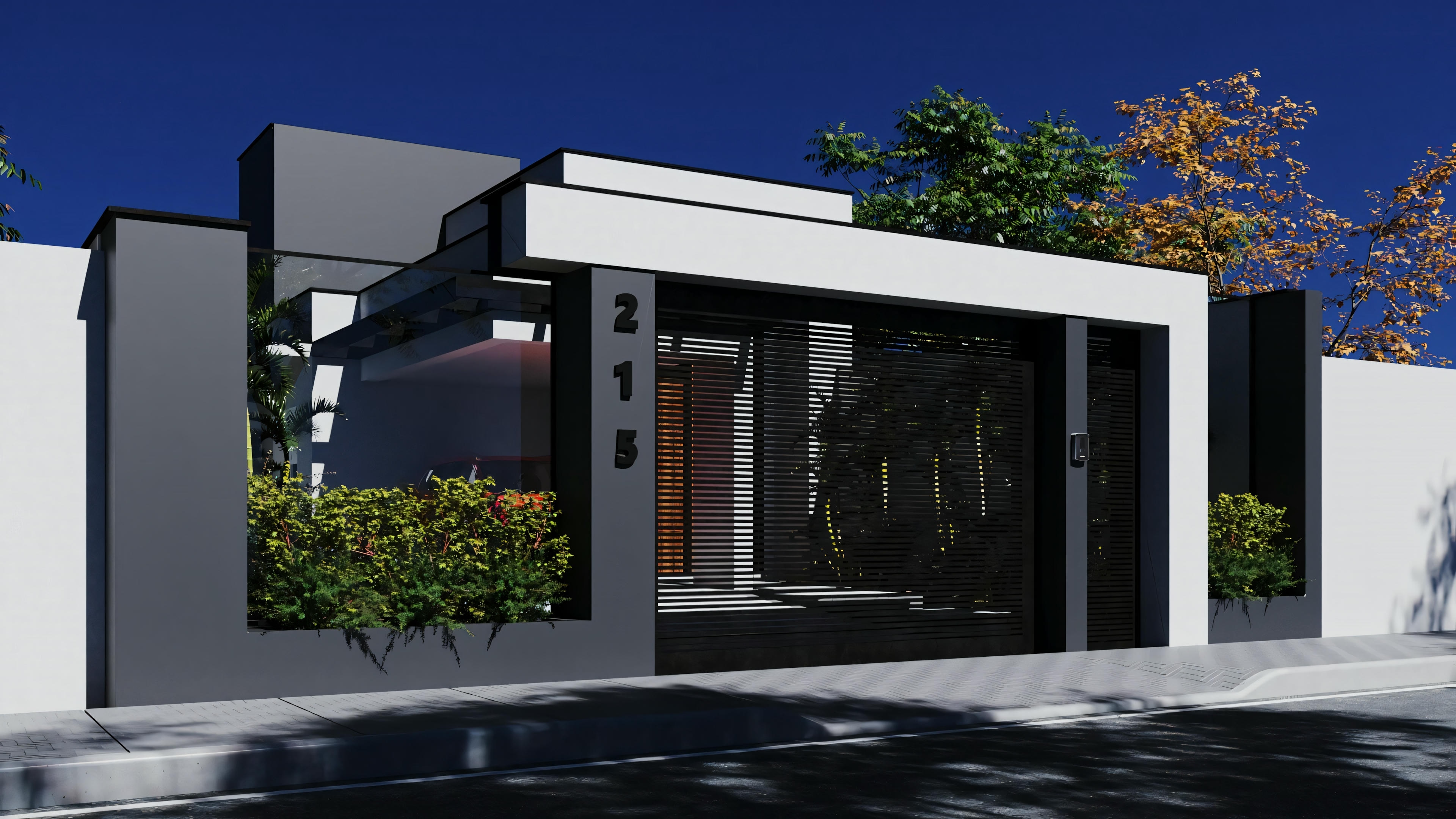 Fachada de una casa moderna al anochecer, con ventanas iluminadas y portón abierto que conduce a la entrada.