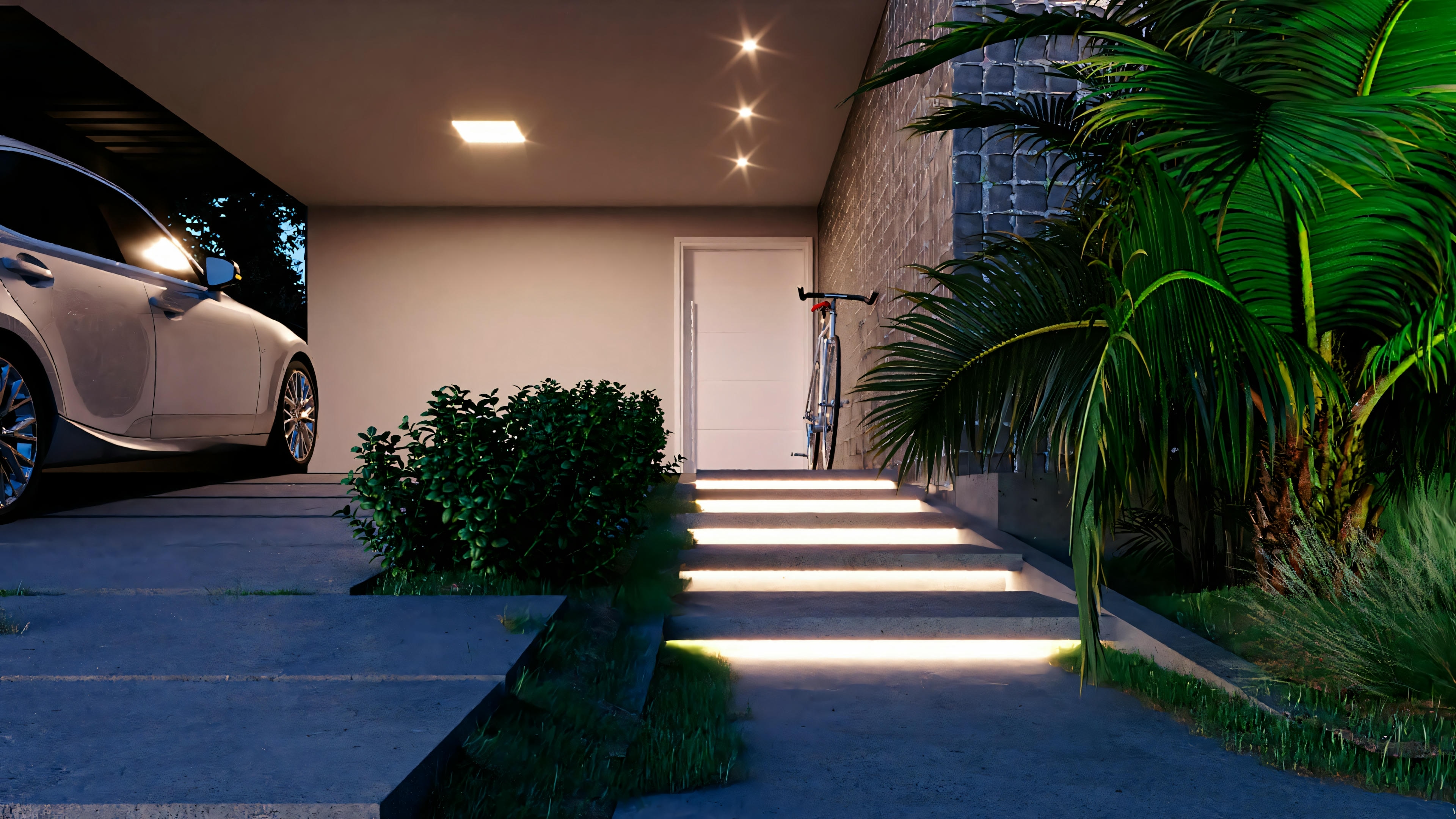 Entrada iluminada de una casa moderna con escalones y plantas a ambos lados.