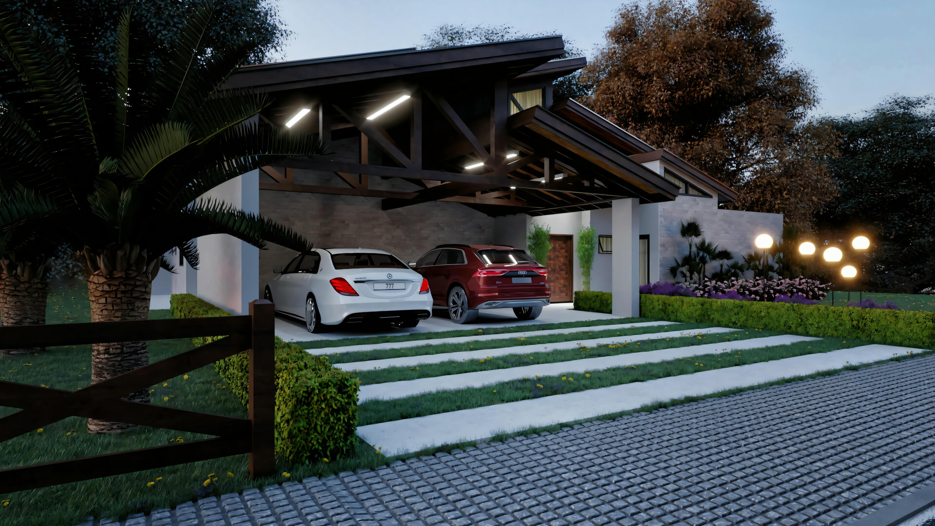 Vista exterior de una casa al anochecer con iluminación exterior, presentando una entrada con coches aparcados y un jardín paisajístico.