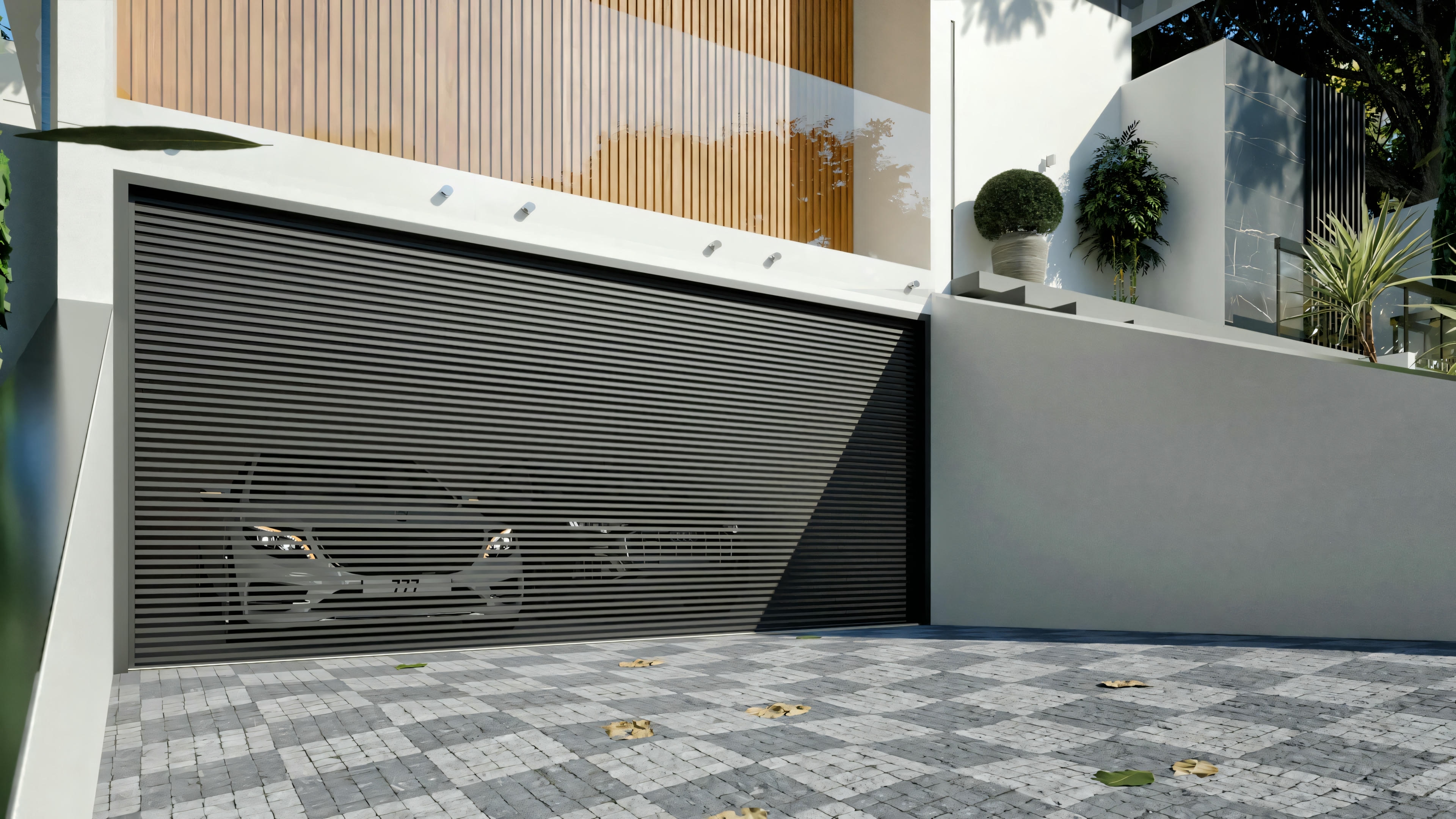 Detail of the 2-car garage of the luxury residential project, with a modern roll-up door and interlocking paver driveway.