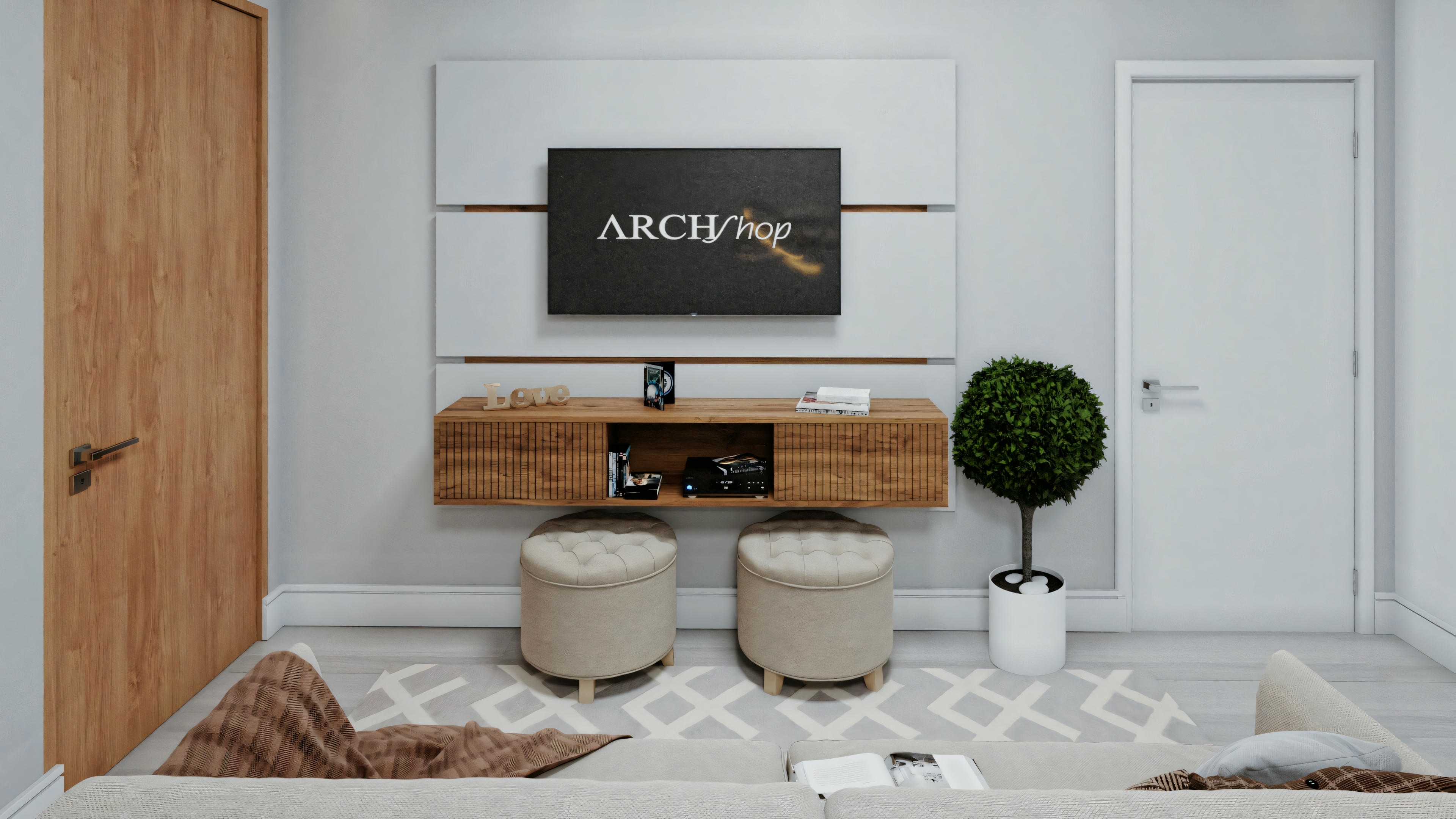 Sala de estar moderna con sofá gris, televisor montado en la pared, mesa de consola de madera, dos bancos redondos con cojines blancos y una planta en maceta a la izquierda.