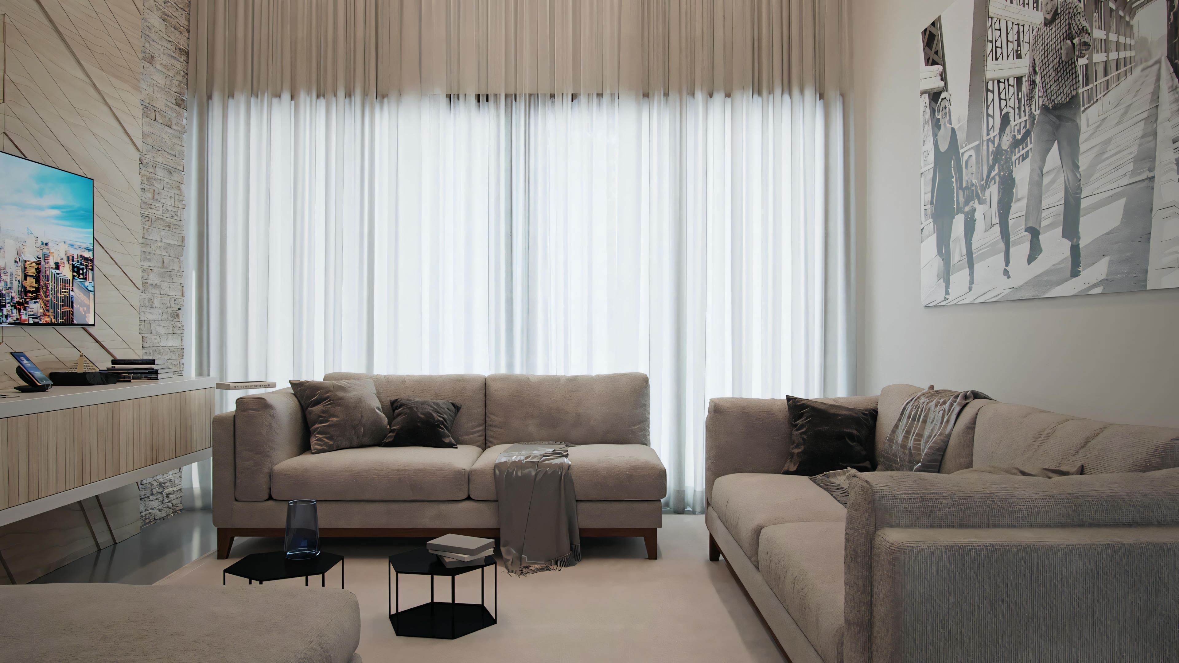 A living room with a gray sofa, matching armchair, coffee table, and sheer curtains covering a large window.
