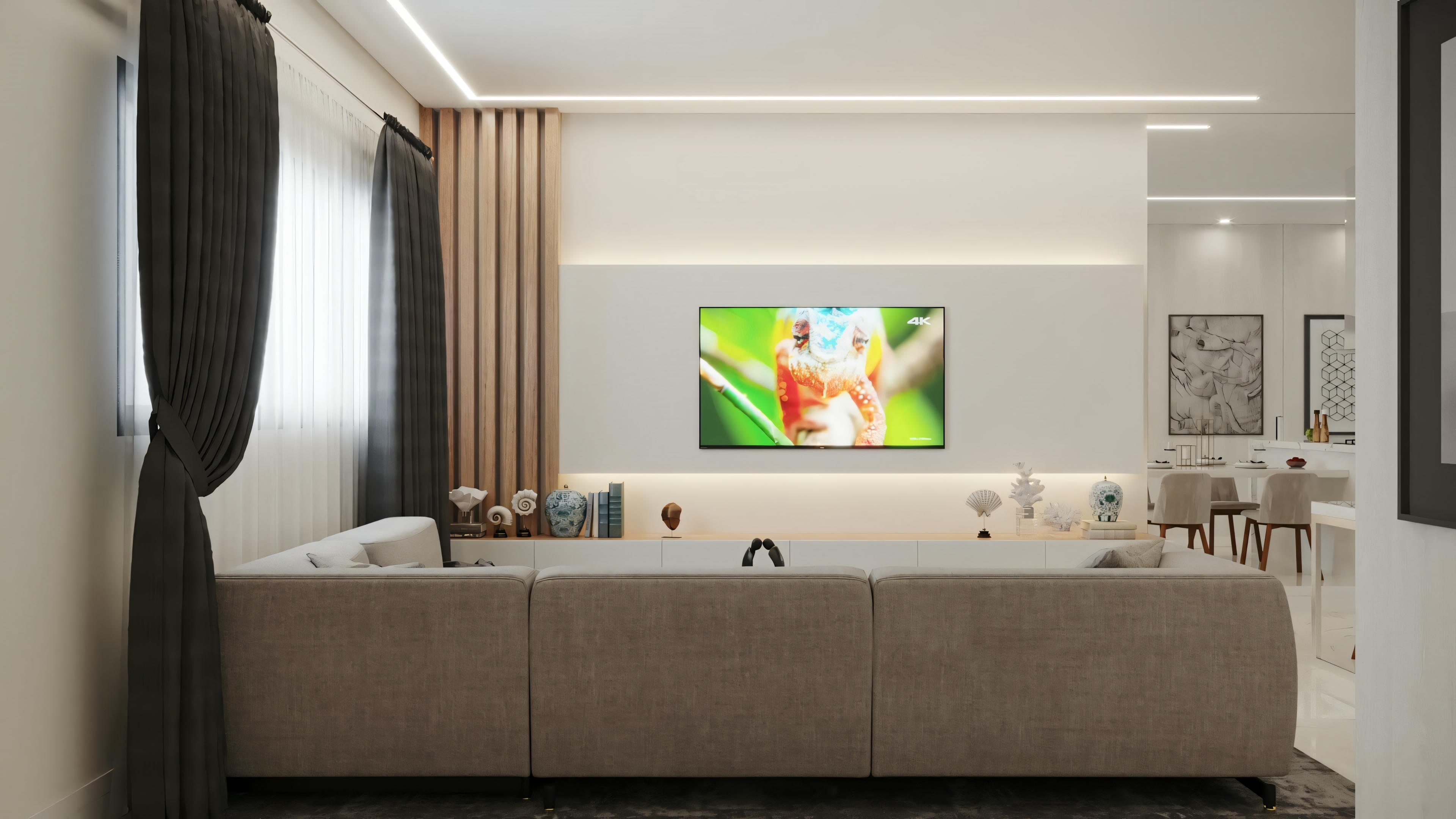 Un salón moderno con un gran sofá frente a un televisor montado en la pared.