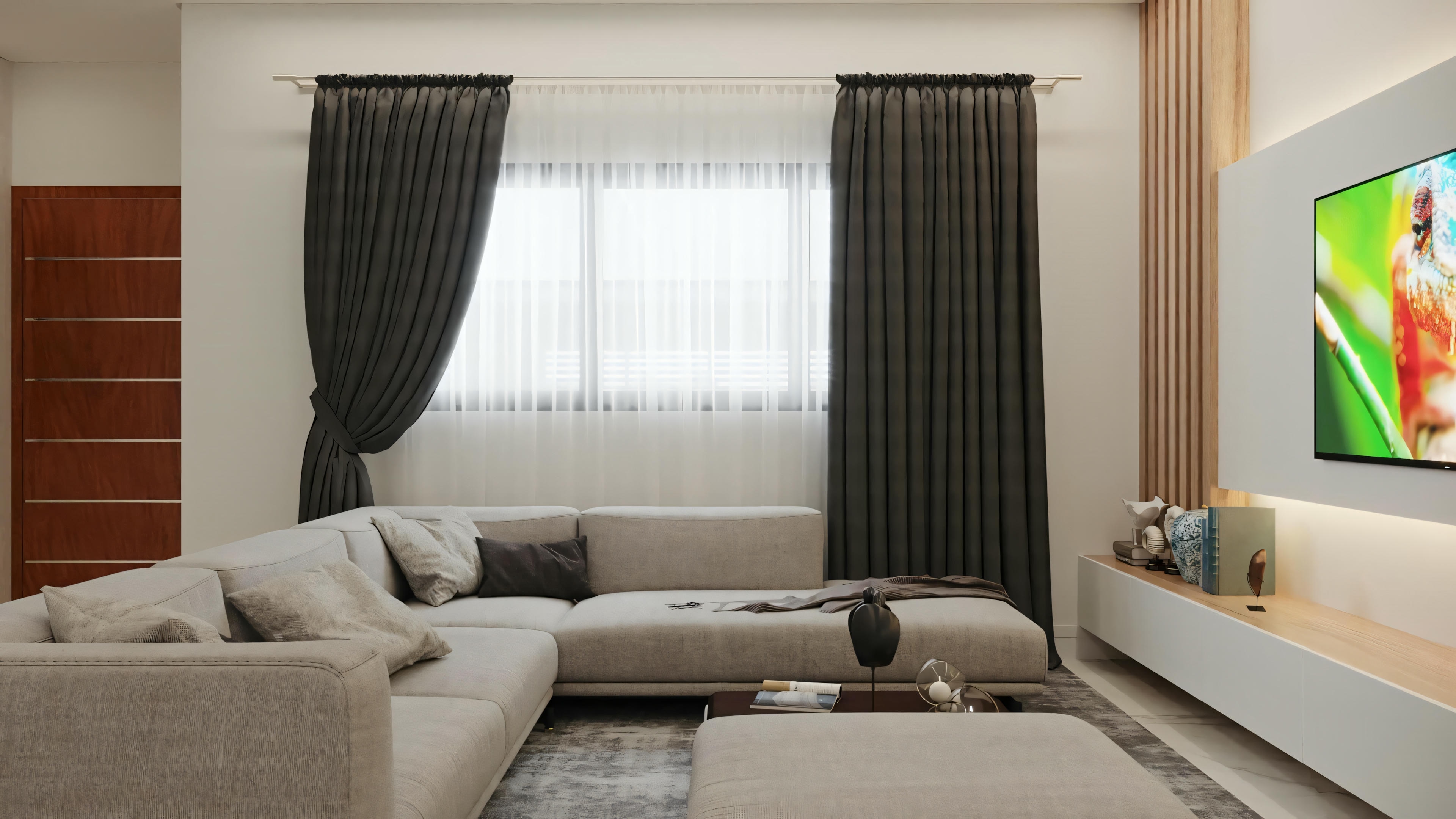 A living room with a sofa, armchair, coffee table, and television on the wall.
