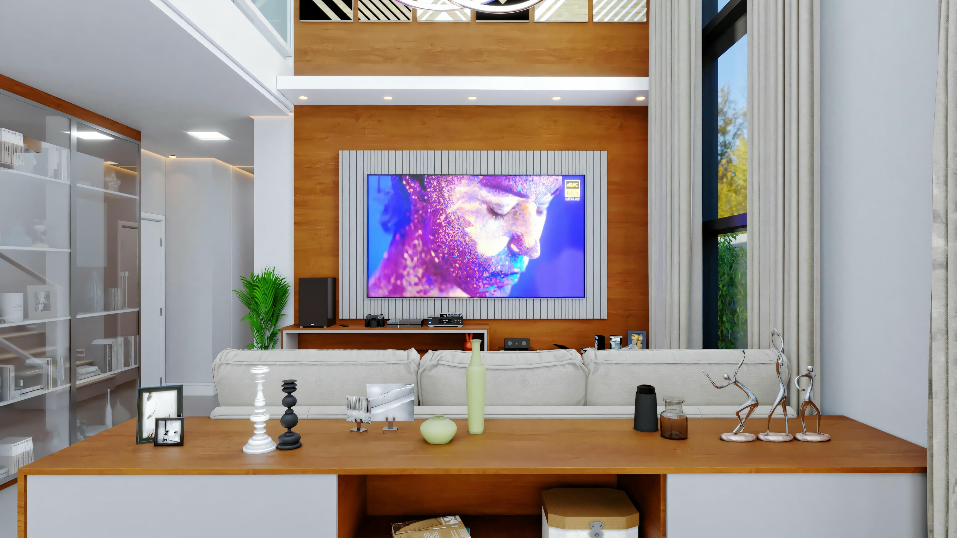 A living room with a large television on the wall displaying colorful abstract art, shelves with decorative items and books, a white sofa in front of a small coffee table, and wood flooring and panels with recessed ceiling lighting.
