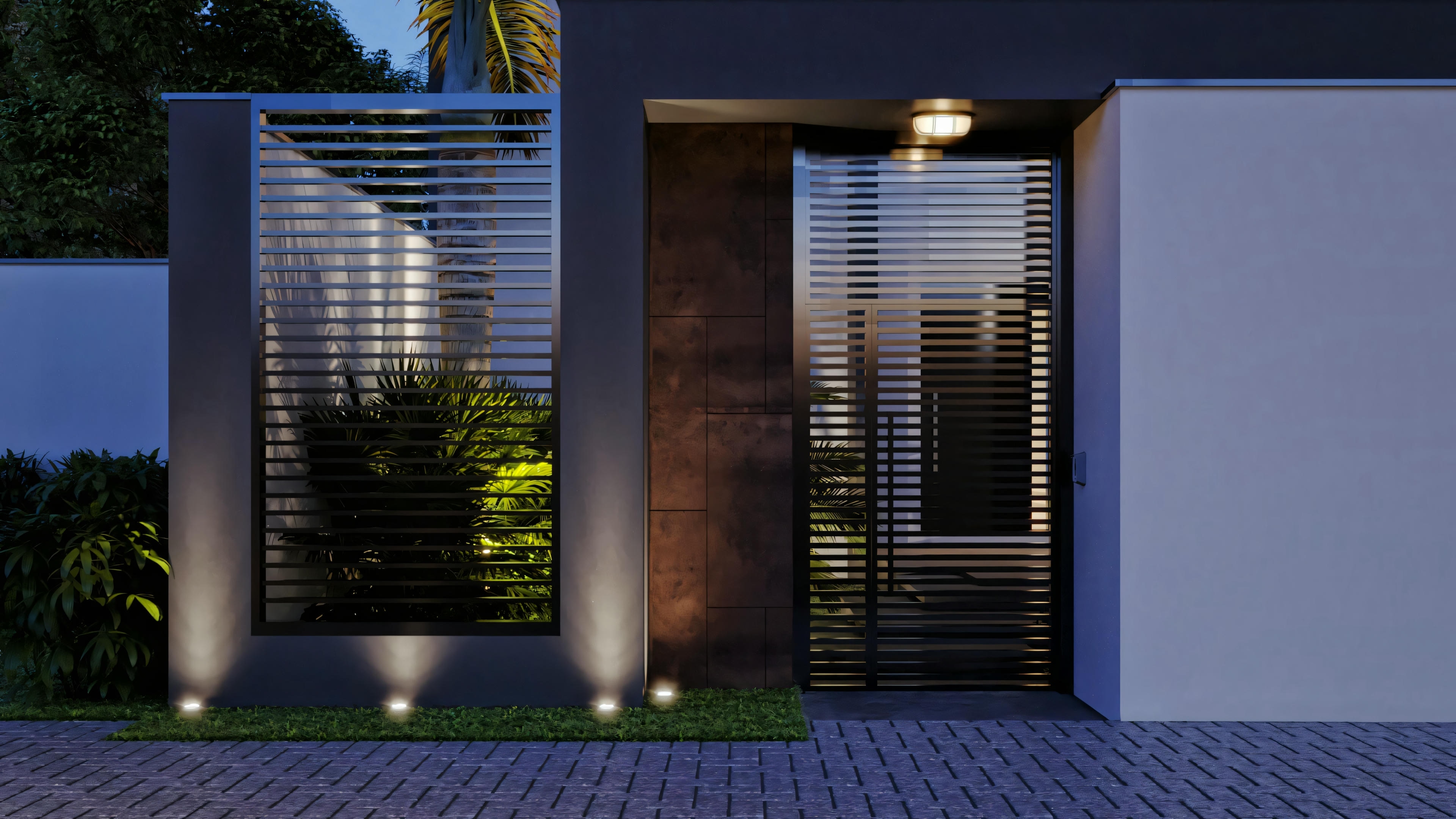 Entrada de una casa moderna por la noche, con camino iluminado llevando a la puerta principal y paredes con jardín vertical.