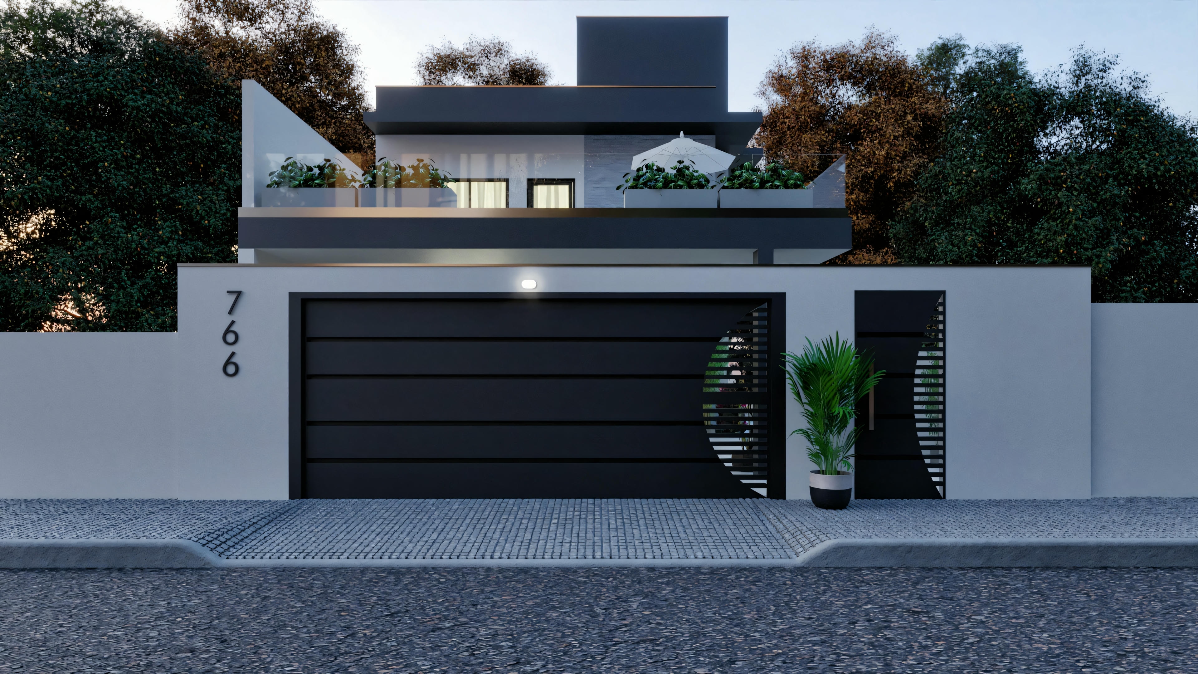 Una casa moderna al anochecer con luces interiores encendidas, destacando una gran puerta de garaje y un área de entrada bien iluminada.