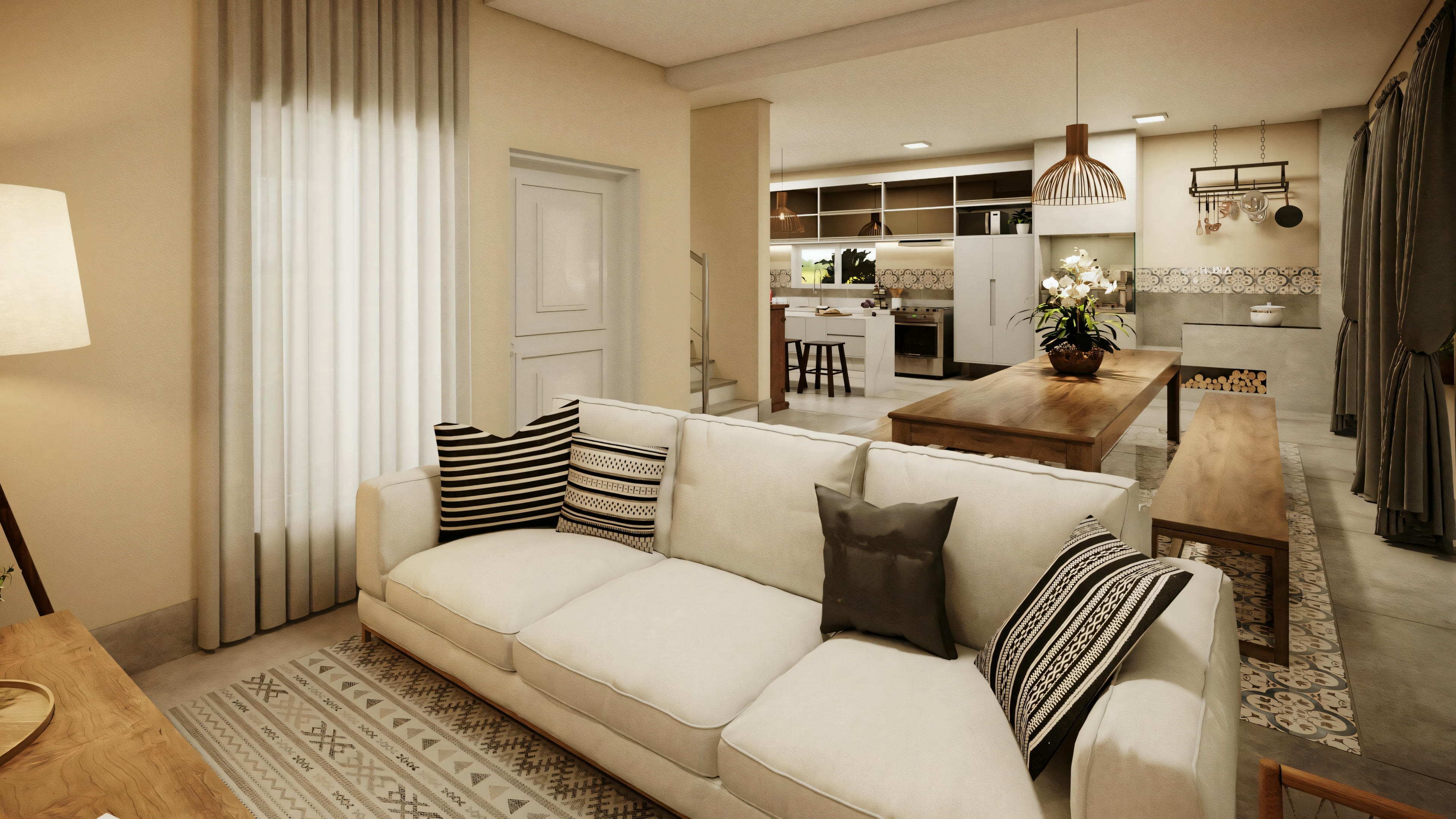 Modern living room with large sofa, coffee table, and patterned rug, leading to a kitchen with stools and pendant lighting.