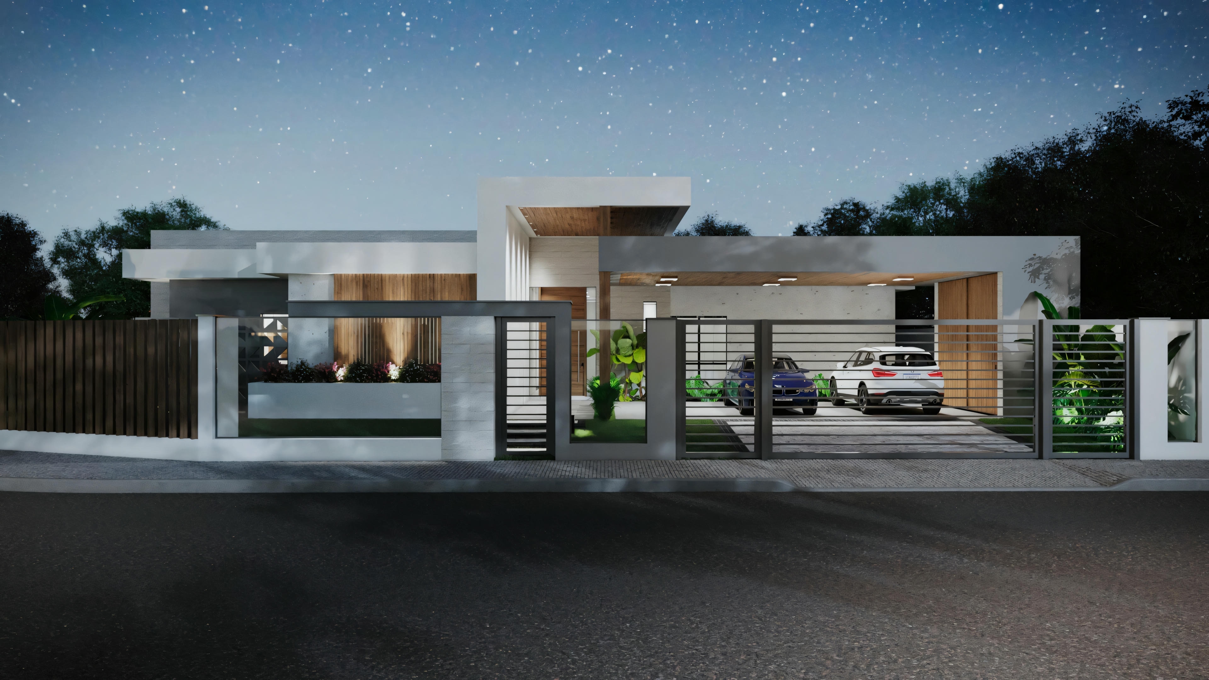 A modern one-story house at dusk or night, with interior and exterior lights on. The architecture features clean lines, large windows, and a flat roof.