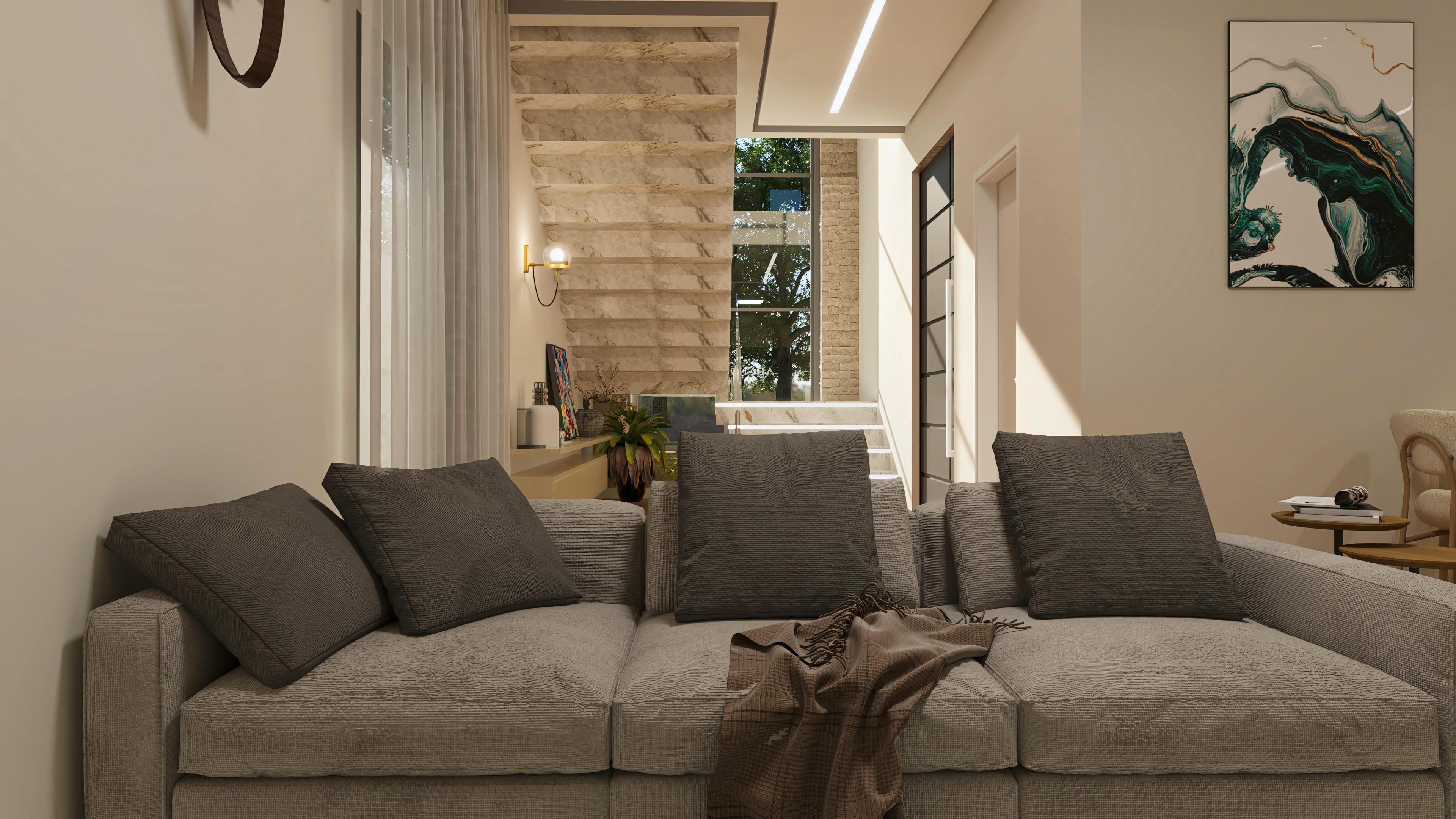 Interior de casa moderna de dos pisos con sala de estar amplia, escalera en mármol y acceso al área externa con iluminación natural.