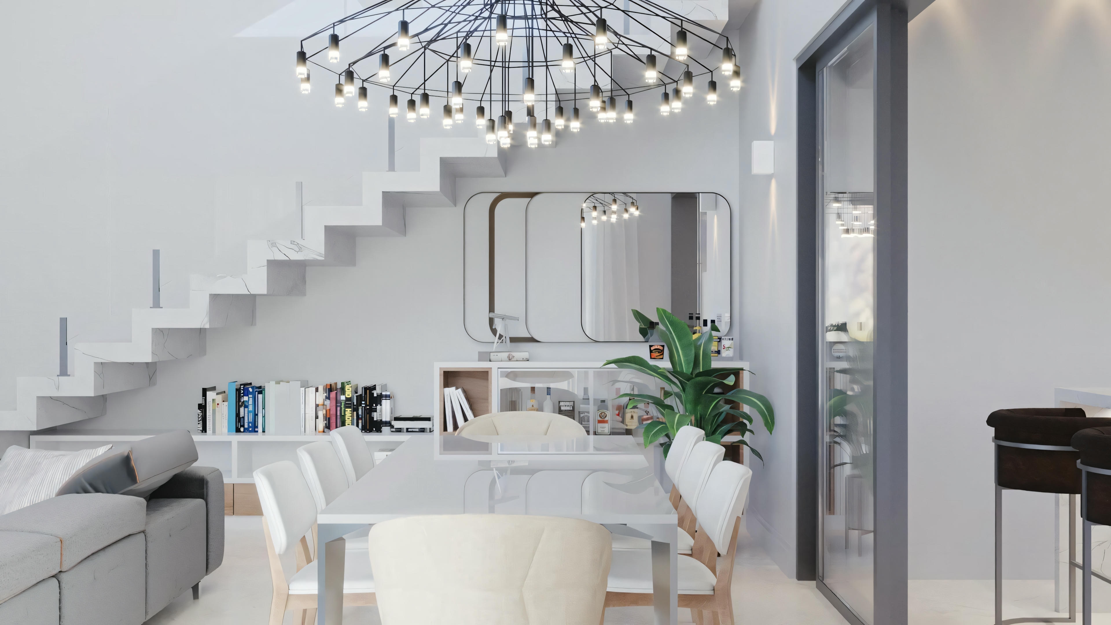 Una escalera con barandal de metal, que conduce a un nivel superior, bien iluminada con luz natural.