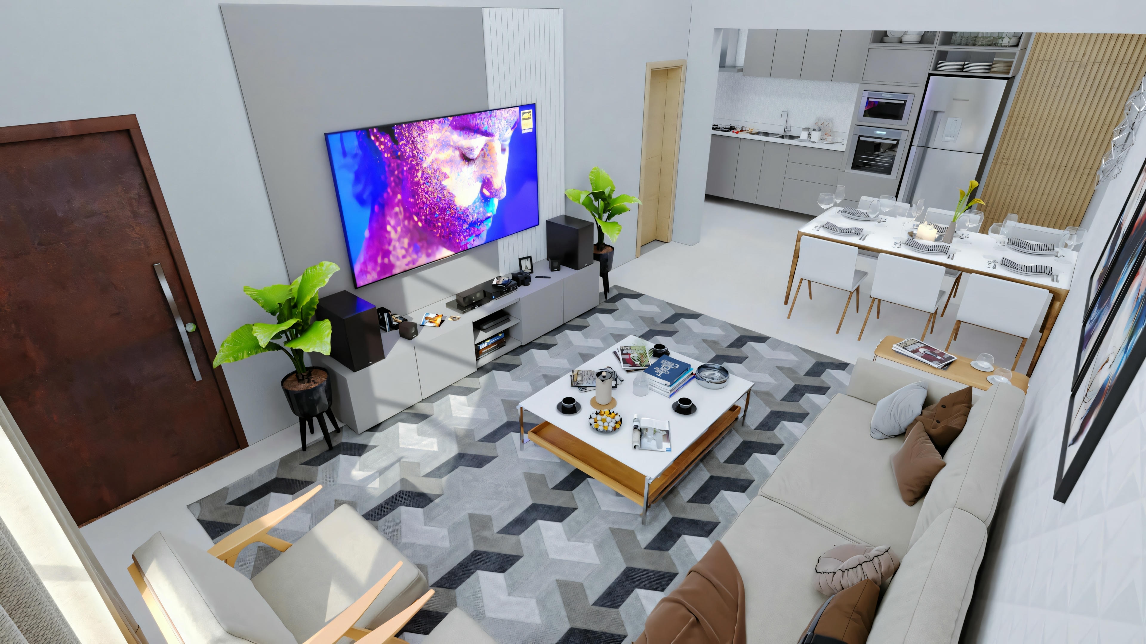 A modern living room with a sofa, coffee table, and wall-mounted television, with an open kitchen in the background.