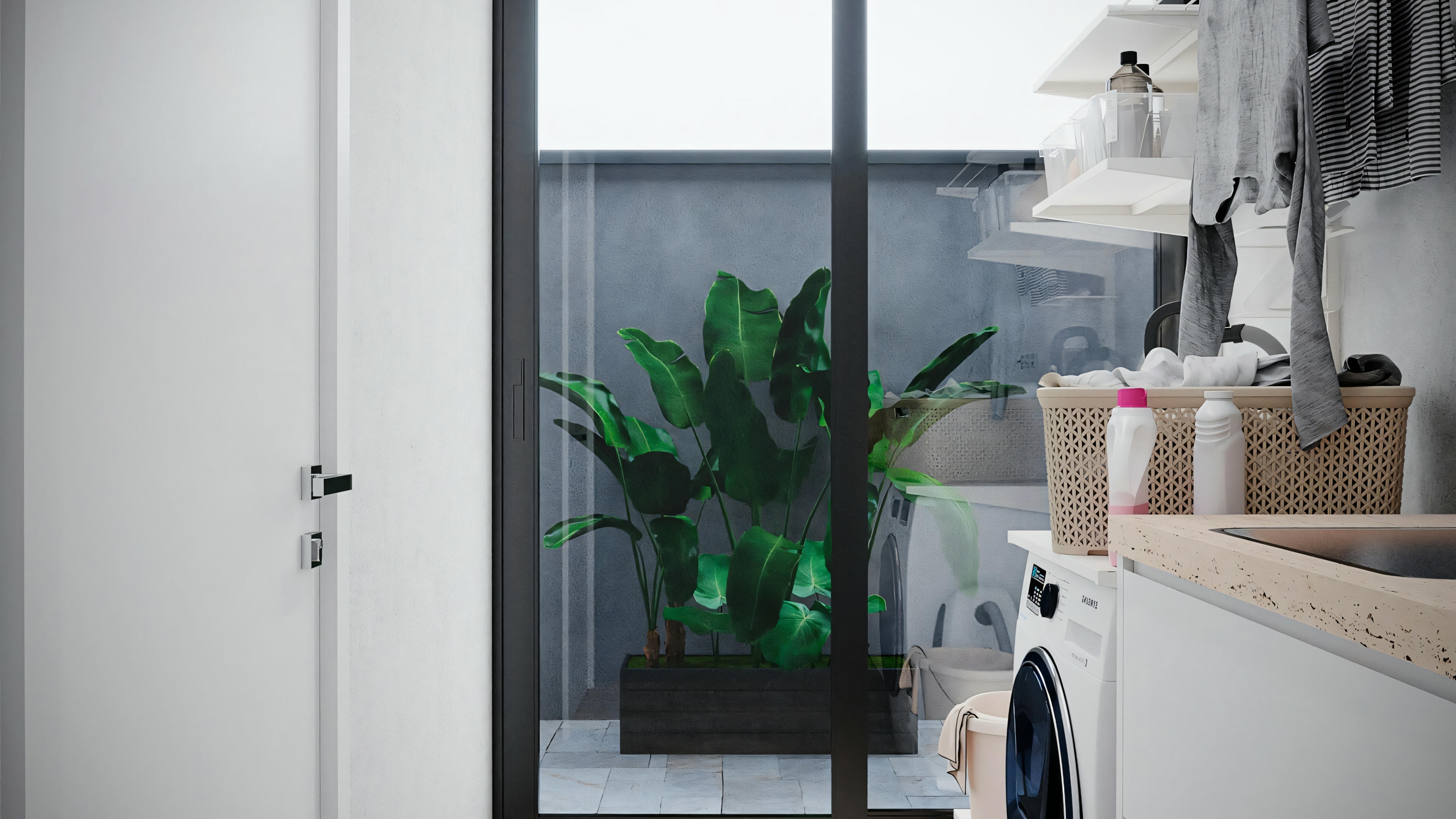 A laundry room with a washing machine, shelves with various items, and a partially open white door.