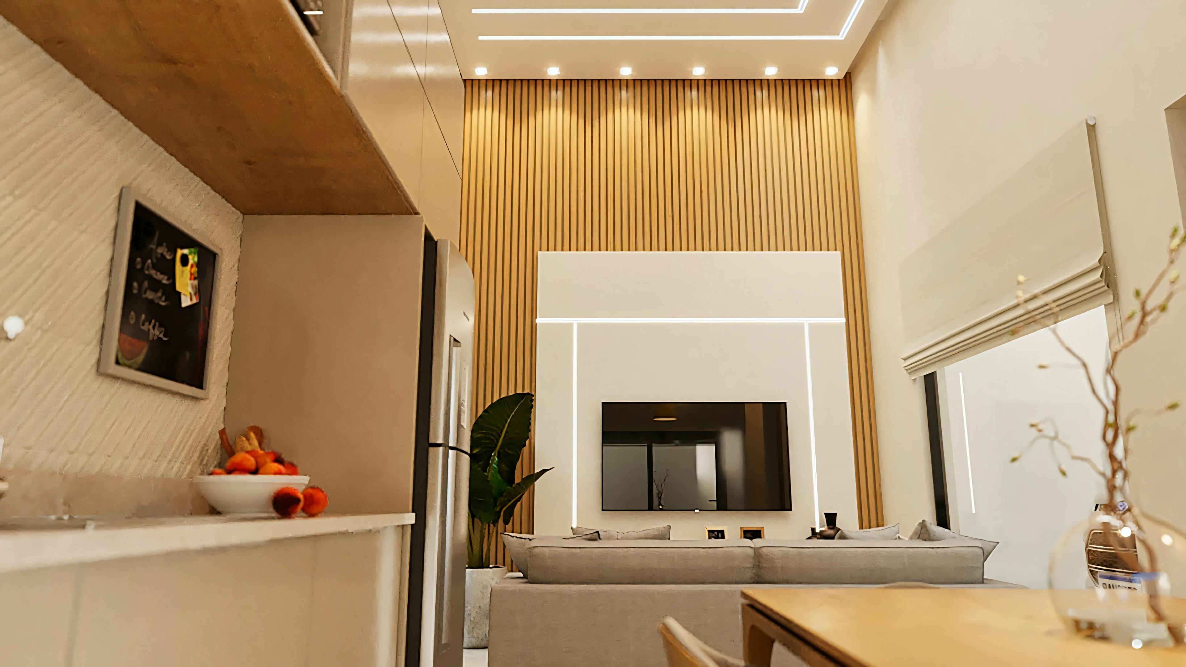 Living room with sofas, coffee table, and entertainment unit with television.
