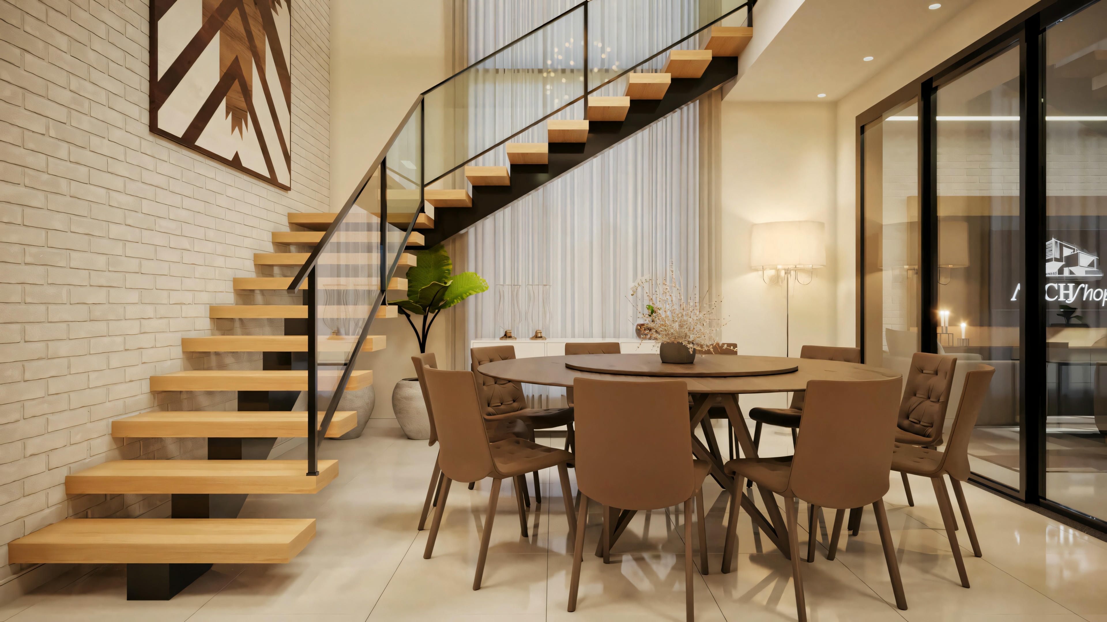 Un comedor con mesa redonda y sillas, adyacente a una escalera que conduce al piso superior.