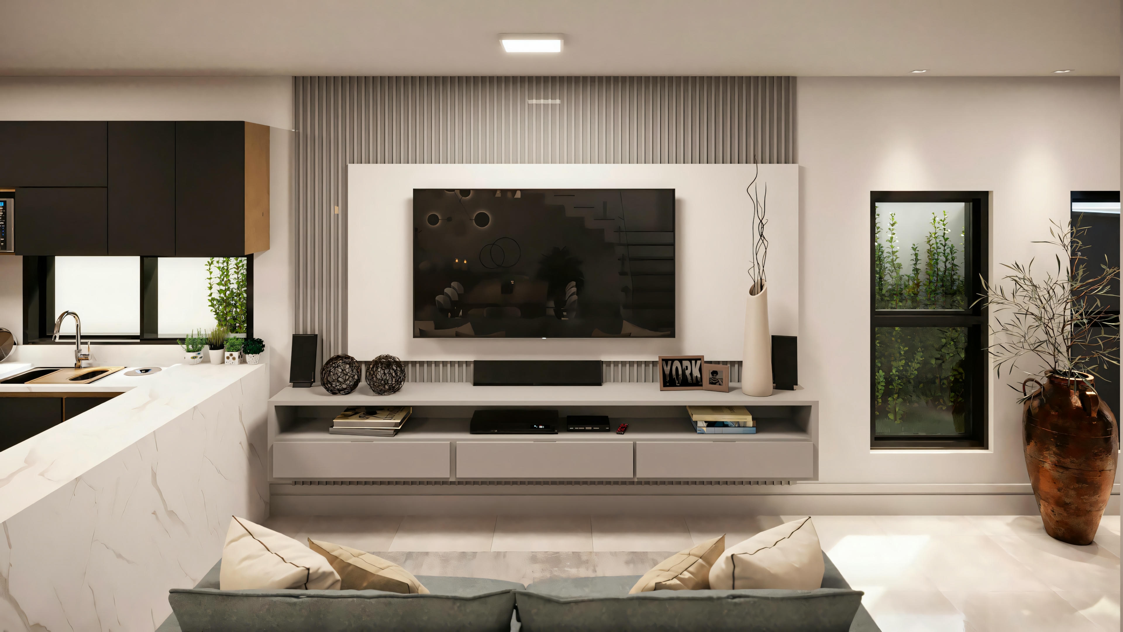 Sala de estar moderna con televisión grande y unidad de estanterías, adyacente a un área de cocina.