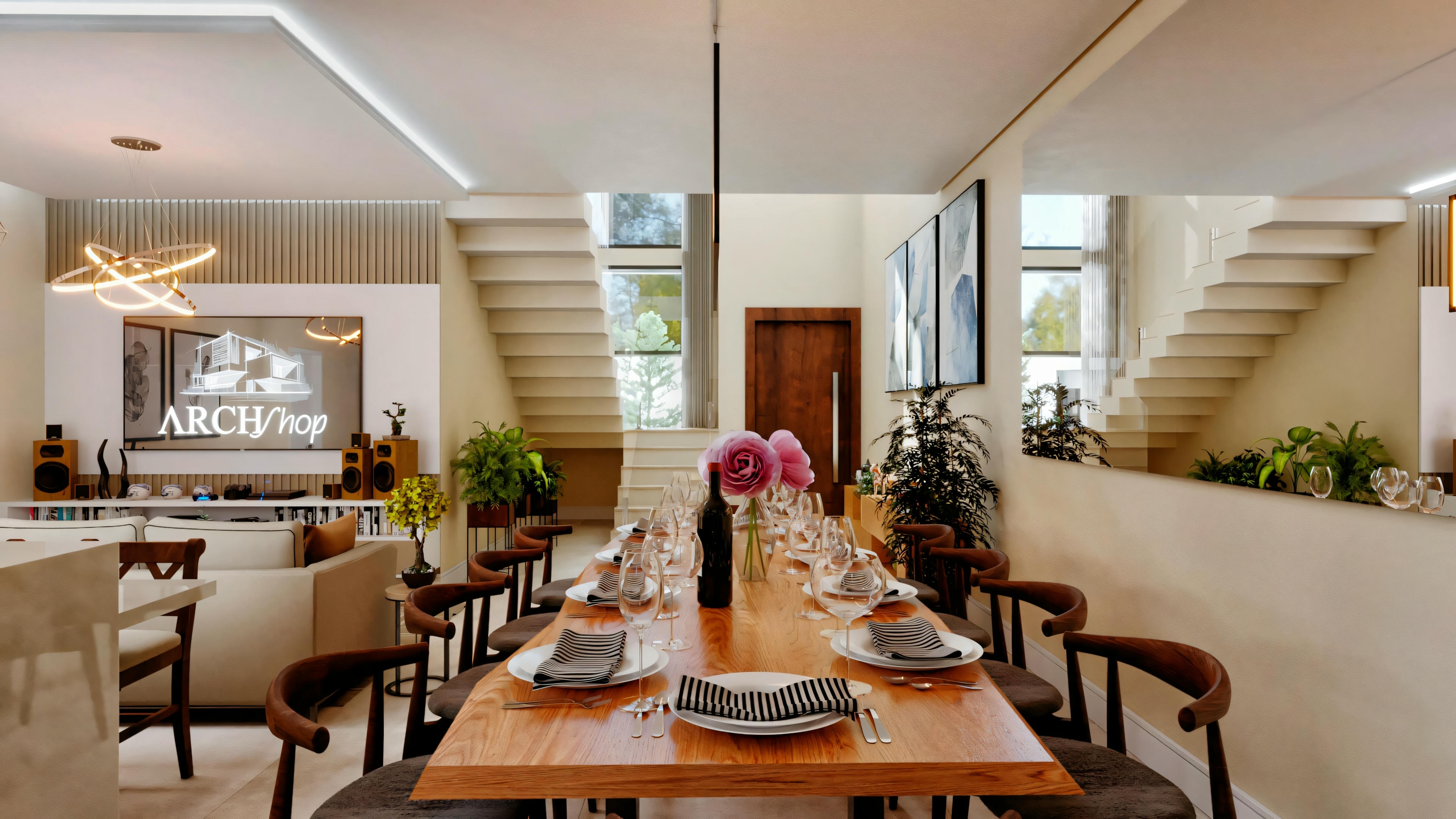 Un área de comedor con una mesa larga preparada para una comida, sillas alrededor y luminarias colgantes encima.