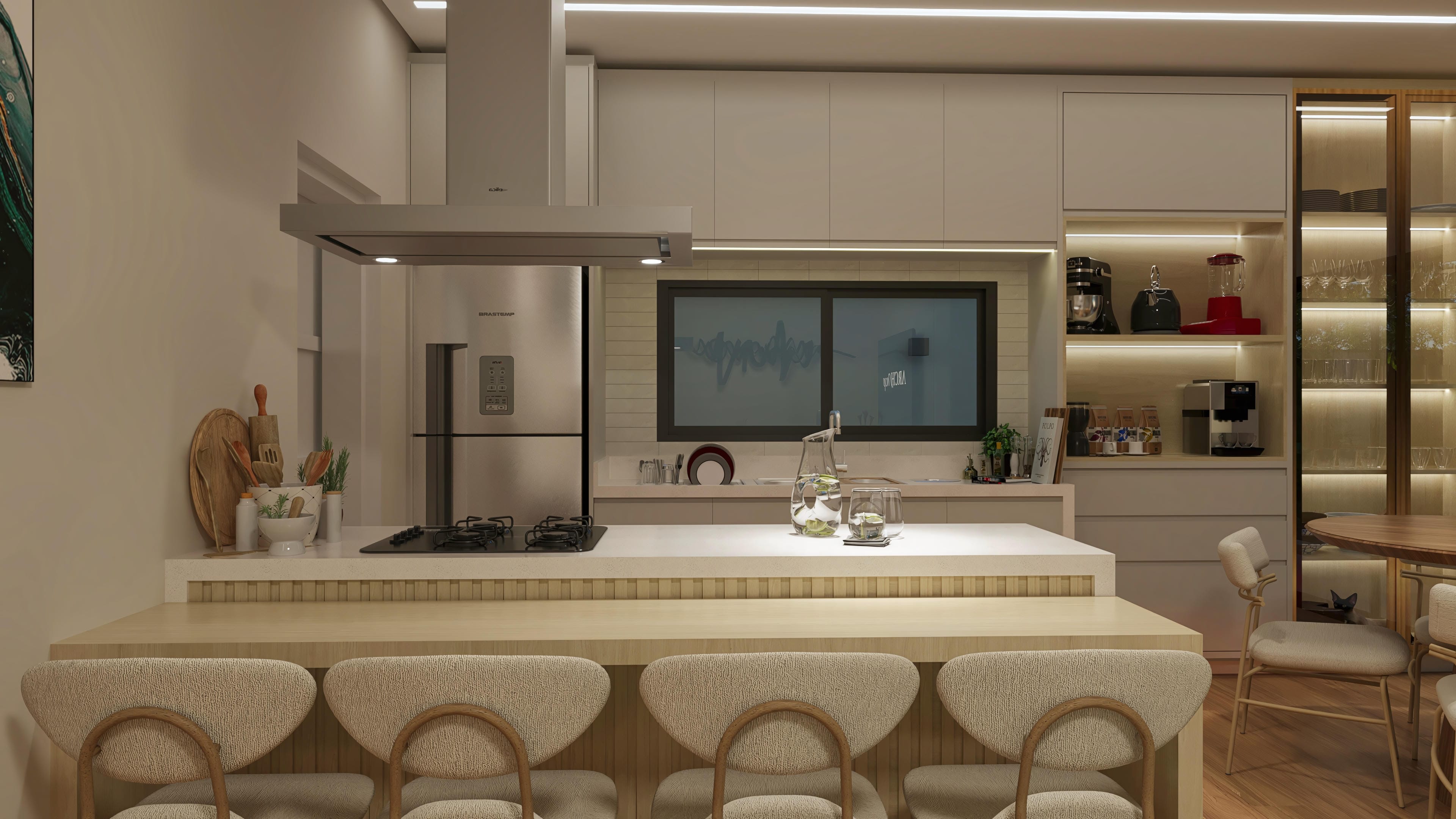 Detalle de una cocina moderna con isla central, armarios a medida y electrodomésticos en acero inoxidable. Destaca el revestimiento en piedra y el mobiliario elegante.