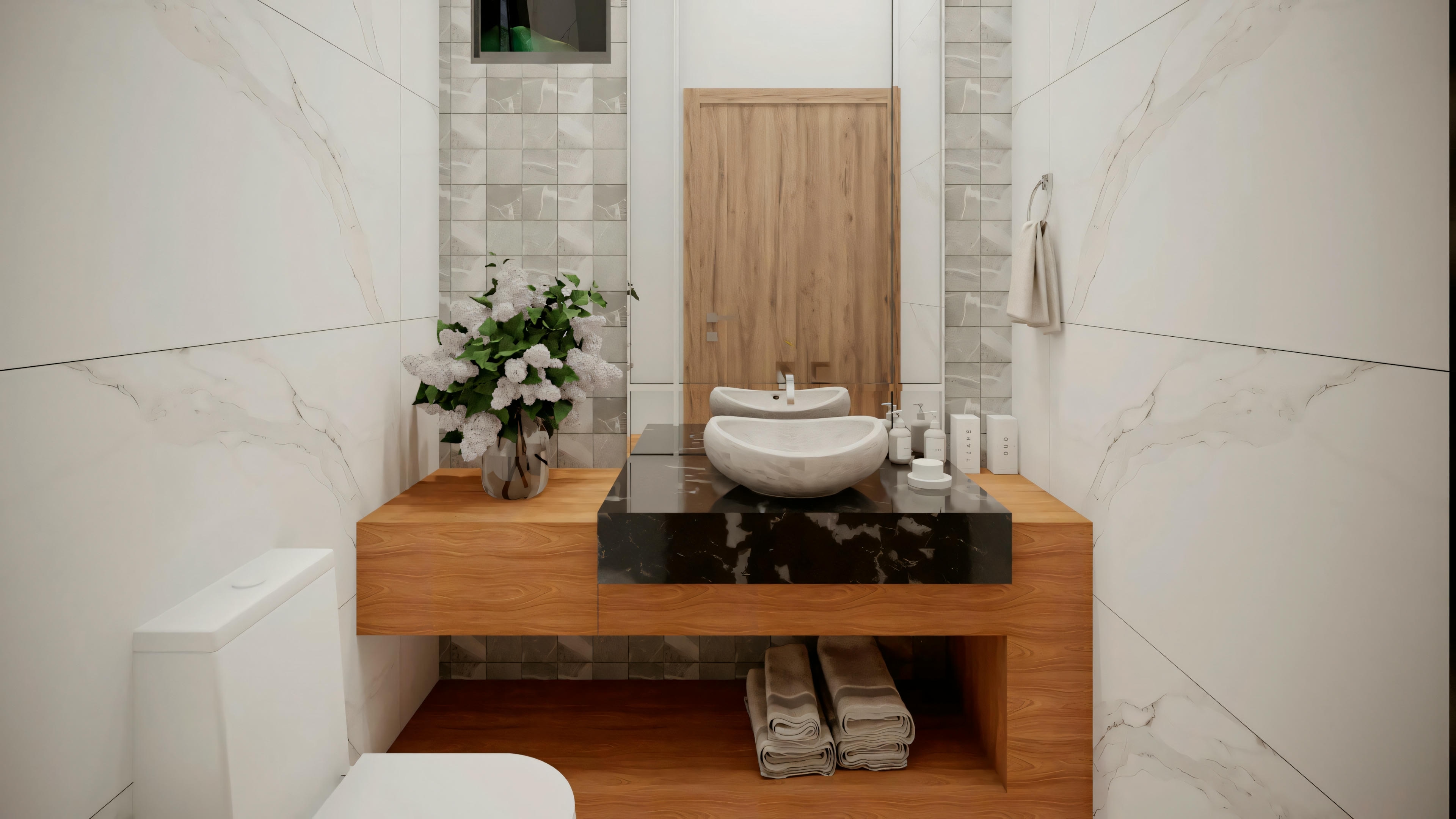 A bathroom with white tiles, toilet, shower area with glass enclosure, and organized towels on shelves, featuring a clean and contemporary design.