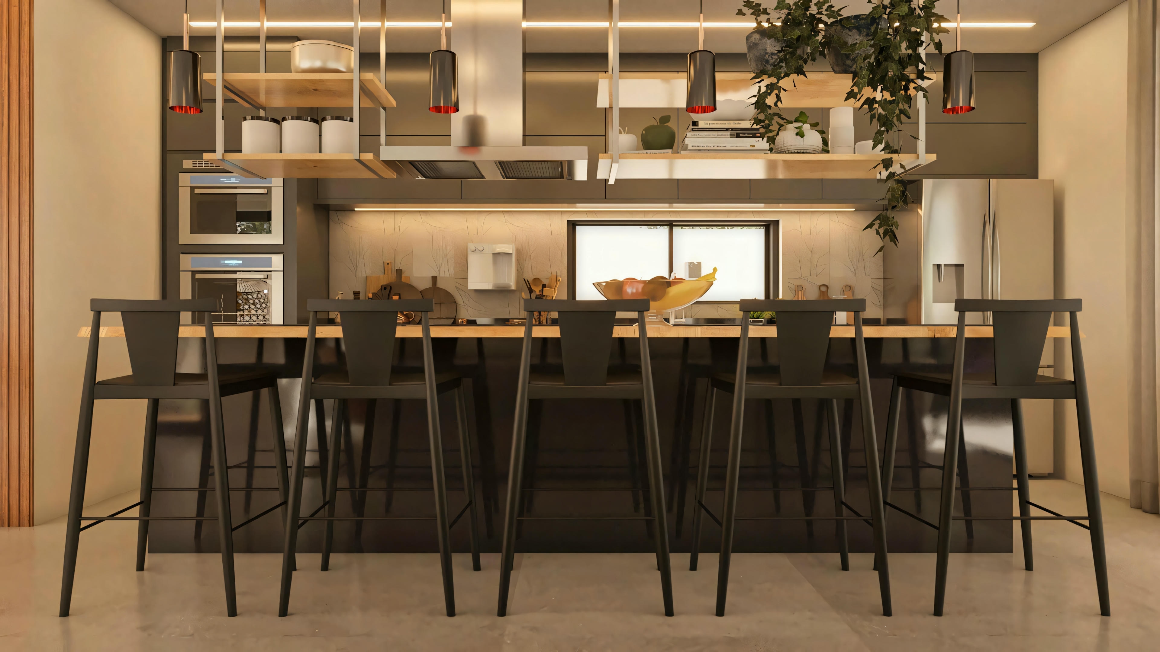 Central island of the gourmet kitchen in the 330m² modern two-story house, with a large wooden countertop, black tall stools, and view of the custom cabinets and appliances in the background.