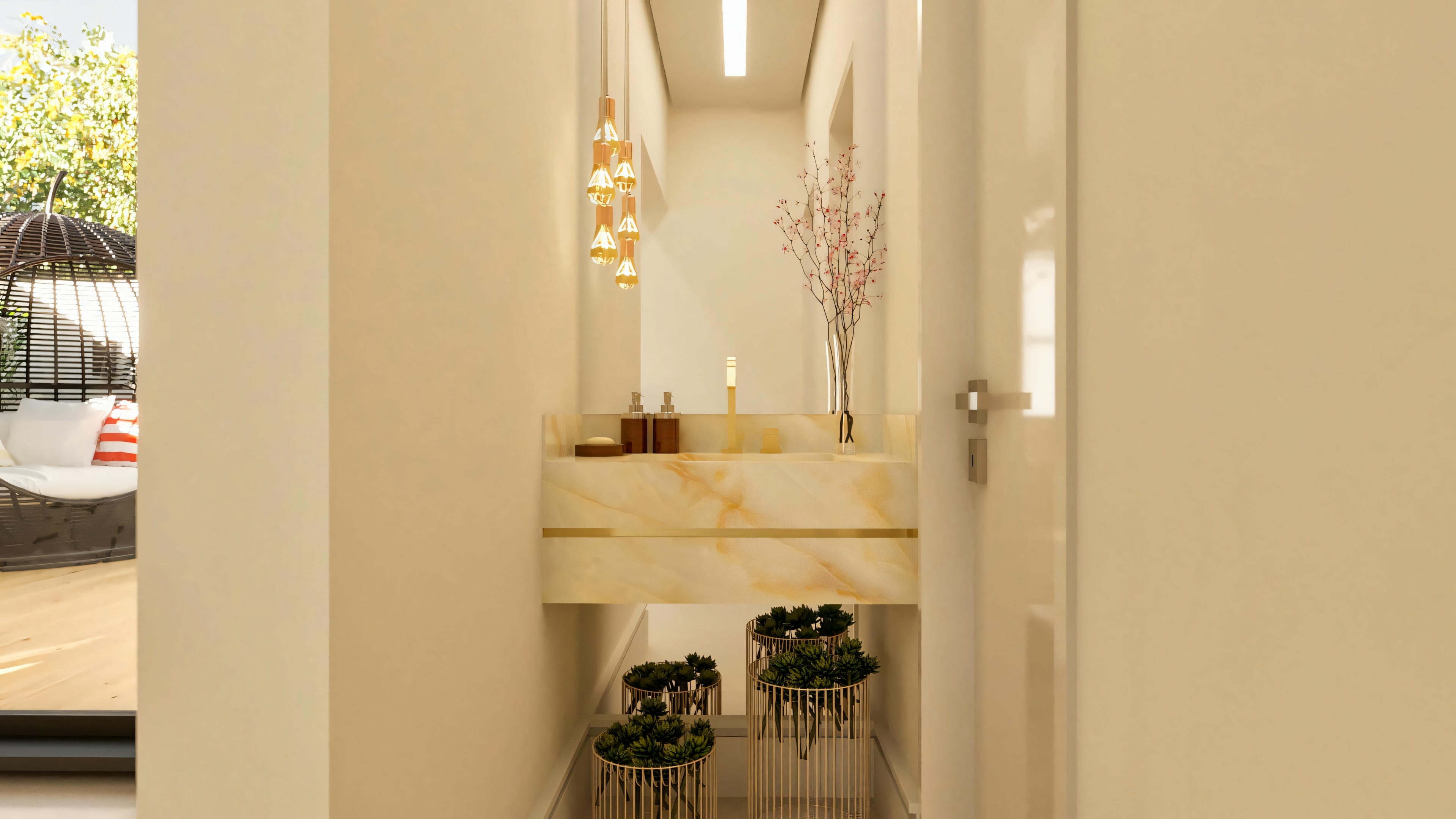 Aseo social moderno en casa de una planta con 3 suites, presentando encimera suspendida en piedra clara (mármol o cuarzo) con lavabo tallado y detalle dorado. Iluminación con lámparas colgantes, espejo, decoración con plantas y puerta de acceso.