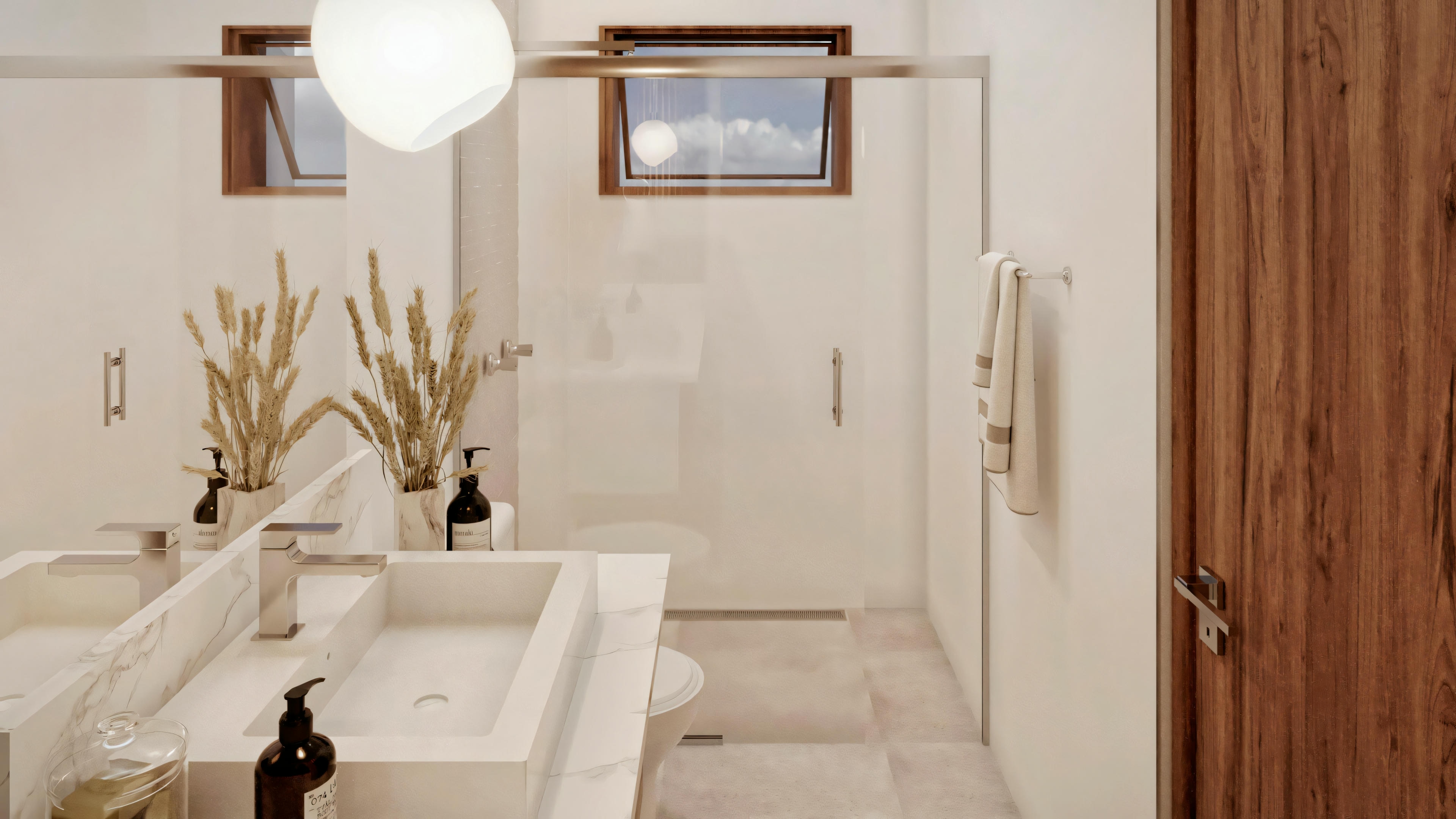 A bathroom with a double sink, two faucets, a large mirror above, and decorative plants on the countertop. To the right, there is a shower area with glass doors.
