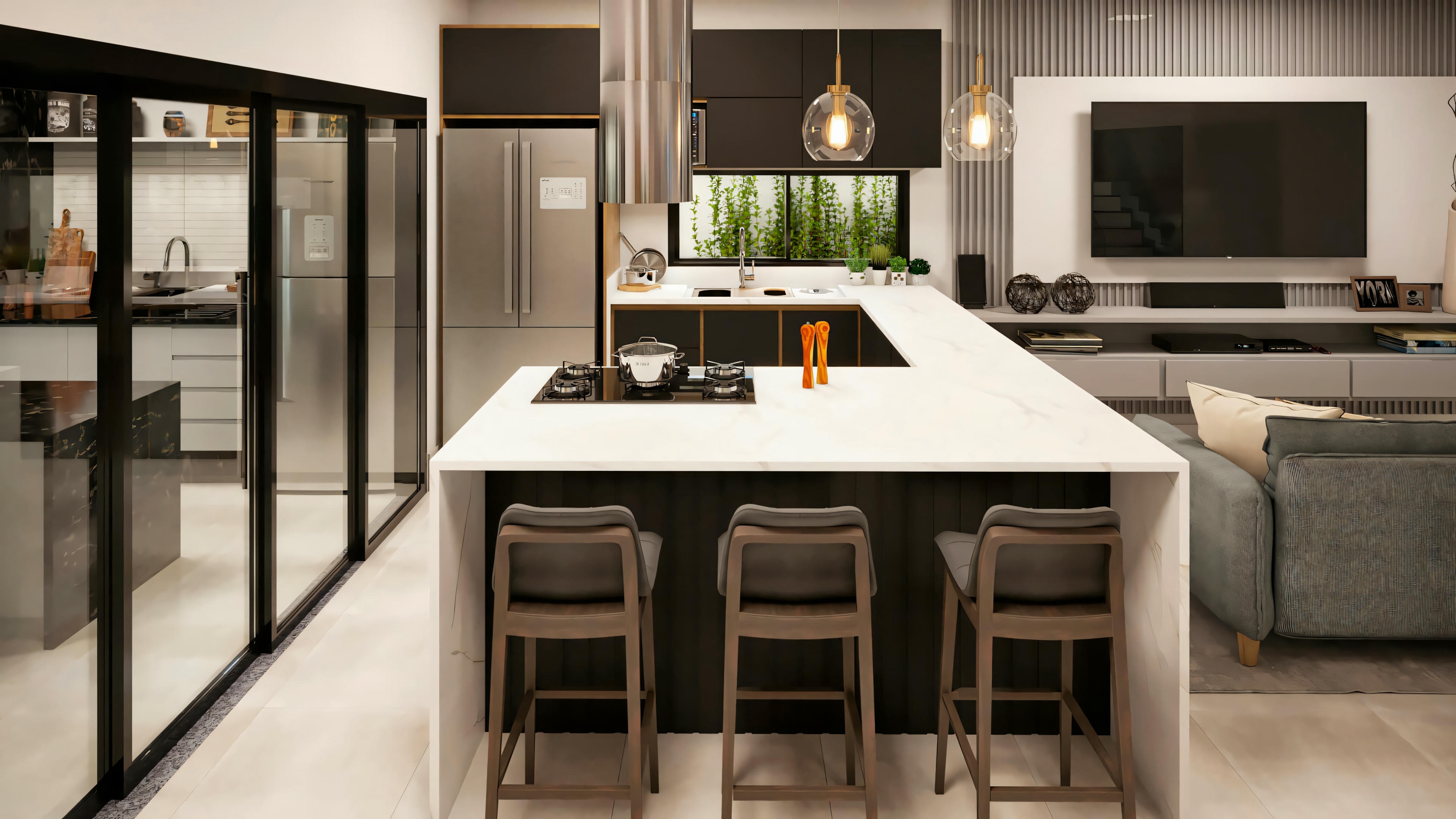 Cocina moderna con armarios blancos, encimeras oscuras, electrodomésticos empotrados y área de comedor con sillas y luminarias colgantes.