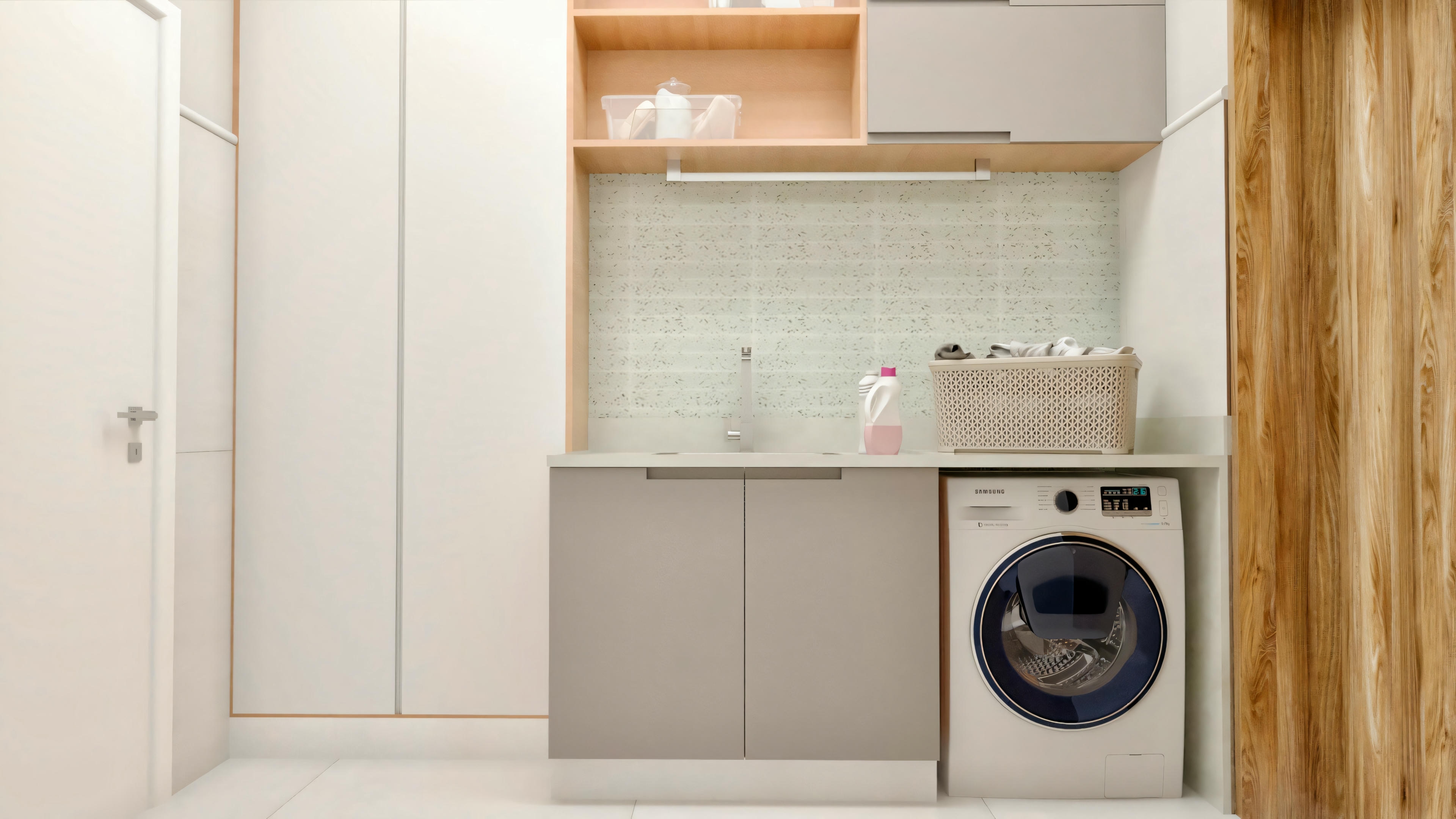 Modern laundry room with a washing machine on the right, a countertop with a sink and soap dispenser, tiles on the wall, and cabinets above the countertop.