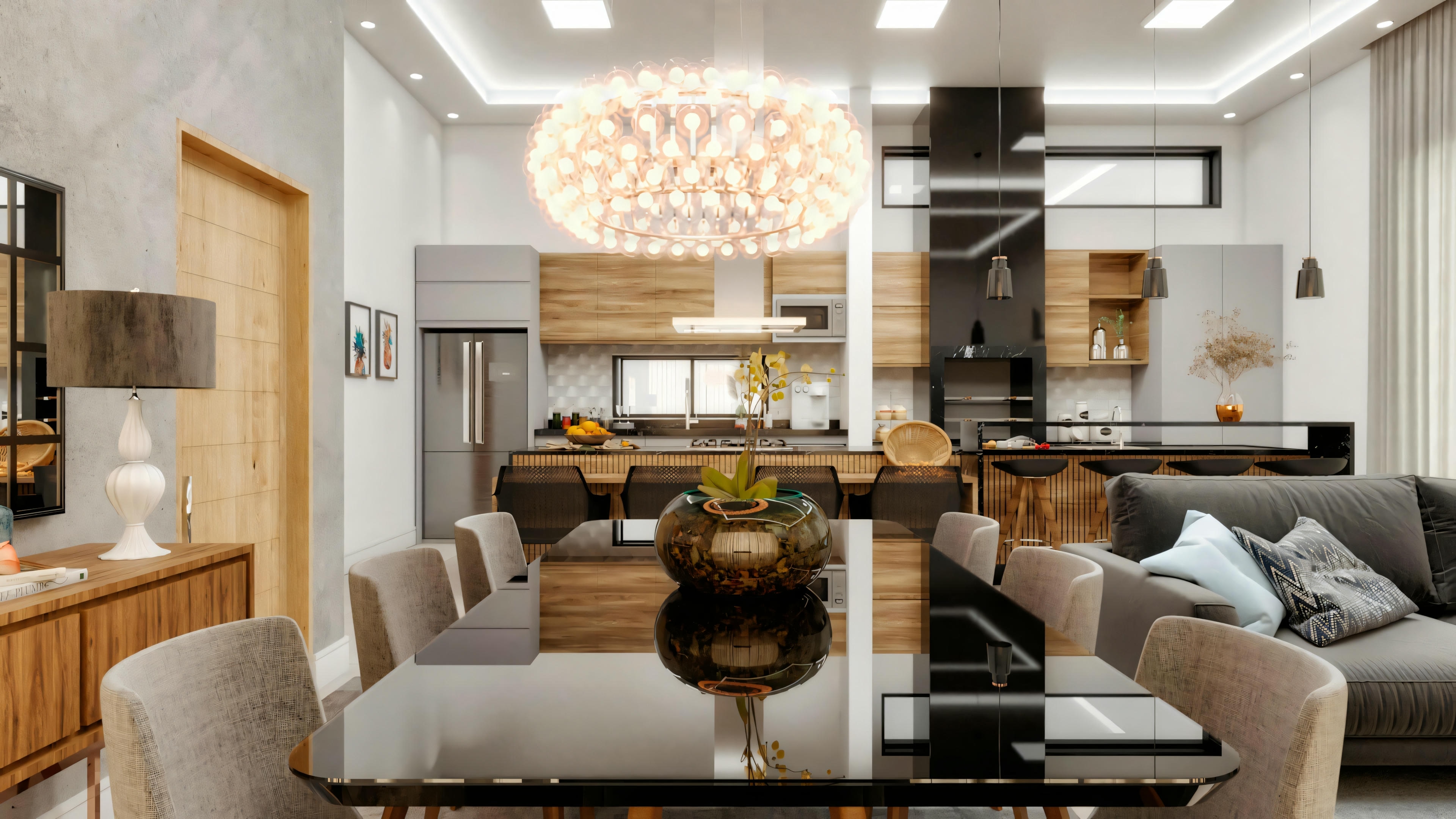 Sala de jantar integrada à cozinha com ilha central em casa de campo, destacando a mesa de vidro e o lustre moderno.