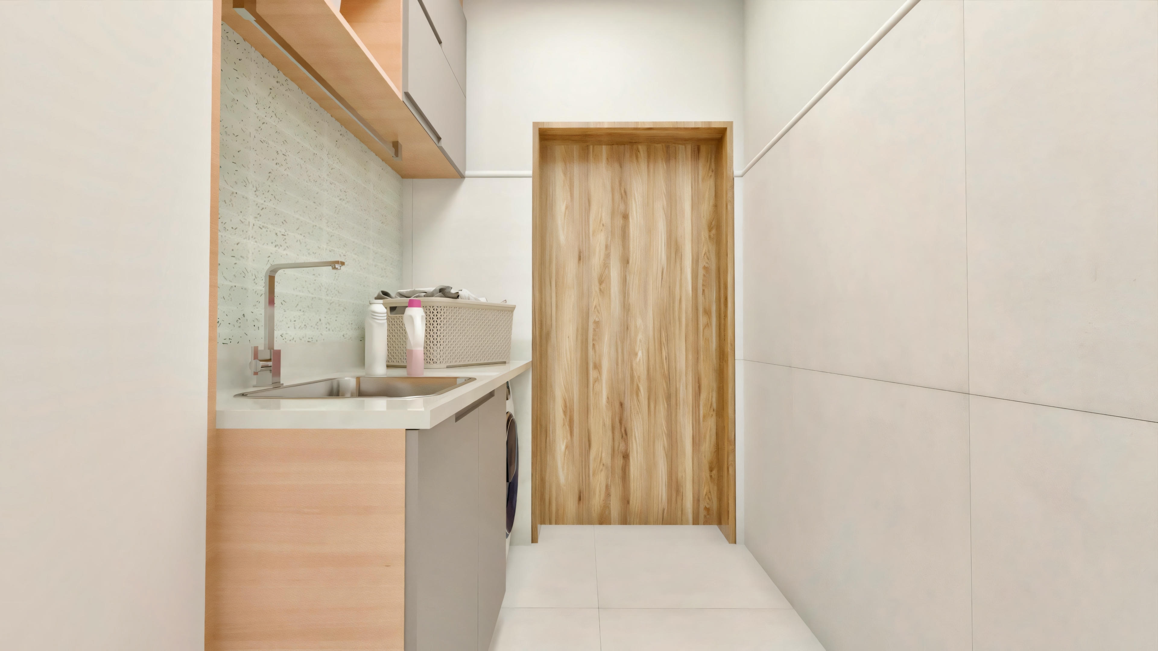 Modern laundry room with a minimalist design, featuring a washing machine under a countertop, cabinets, and a sink.