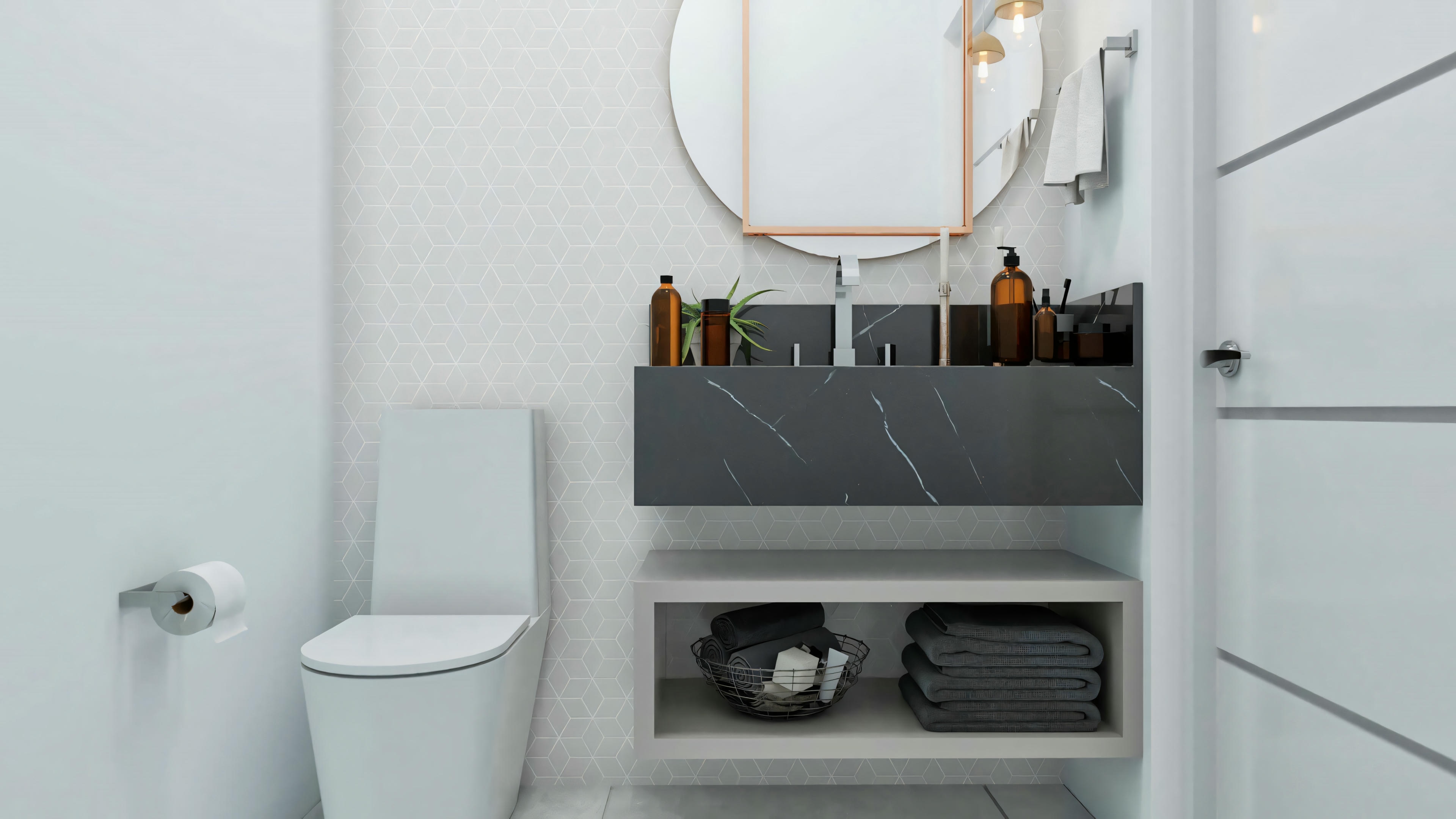 Baño moderno en la casa de dos pisos 10x25, con encimera flotante en piedra oscura, espejo redondo, nicho inferior para toallas e inodoro acoplado.