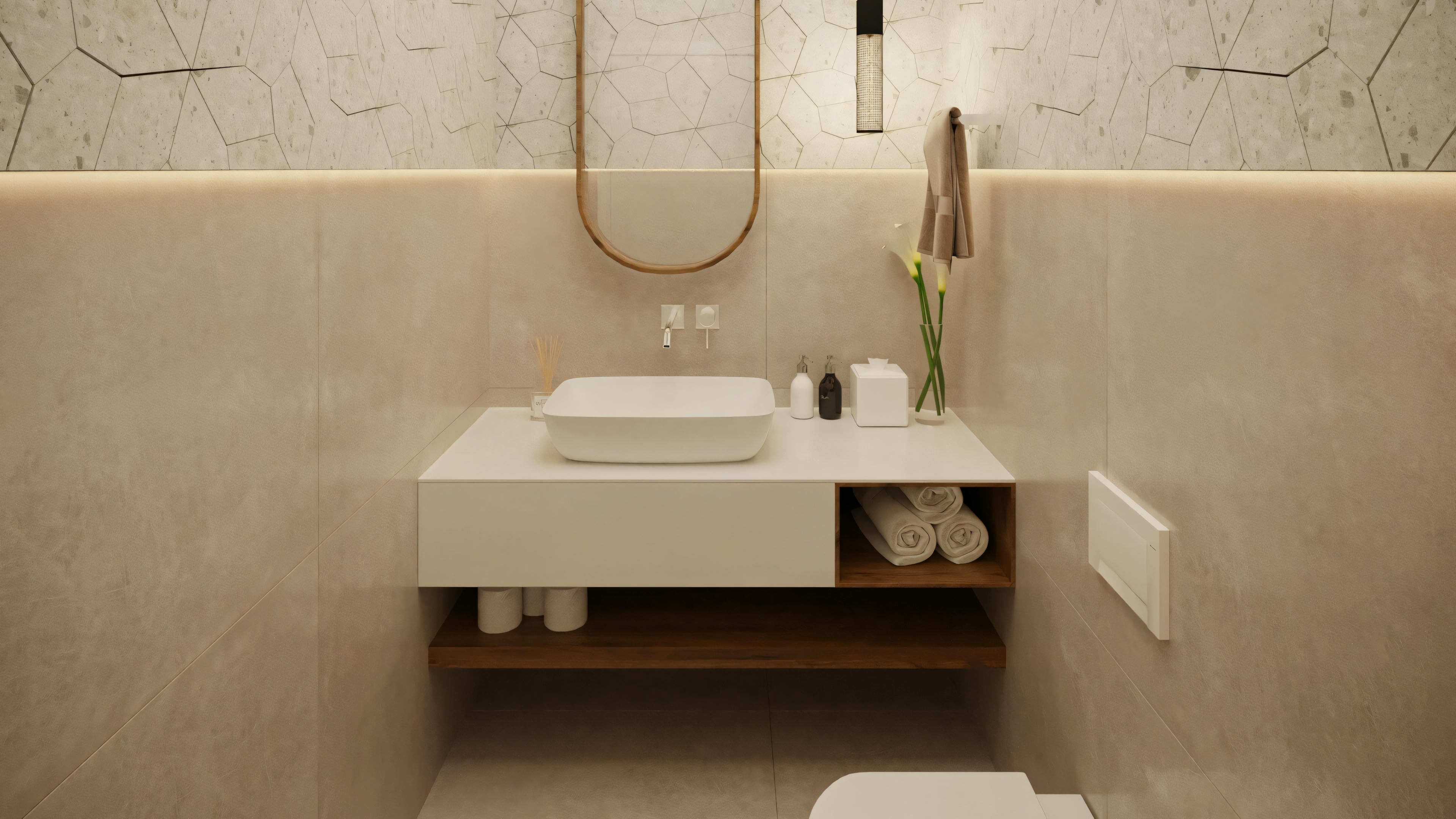 A bathroom with a white sink and gold fixtures against a tiled wall.