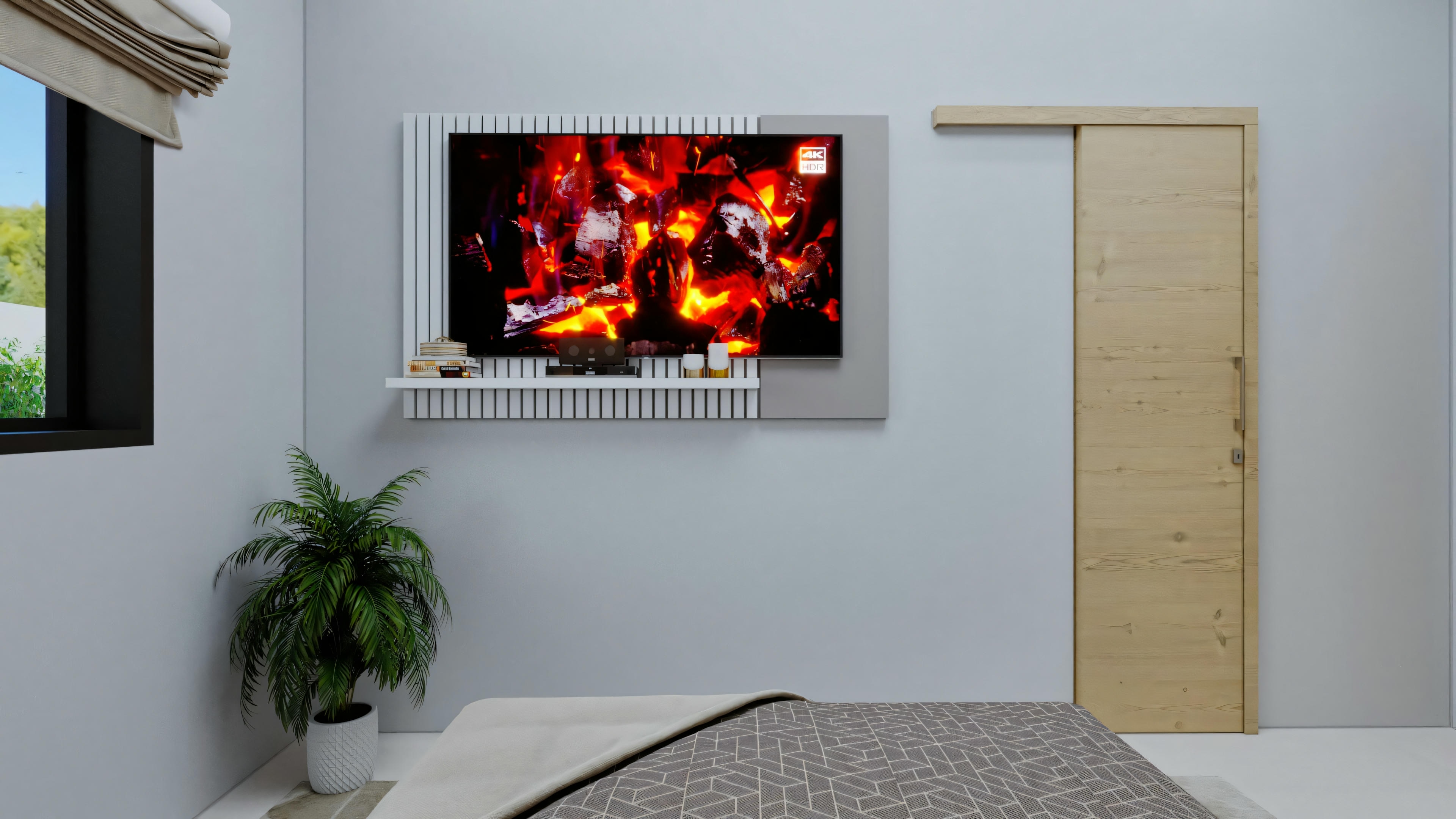 Un dormitorio con una cama en primer plano y una televisión montada en la pared mostrando una imagen de fuego encima de un calefactor.