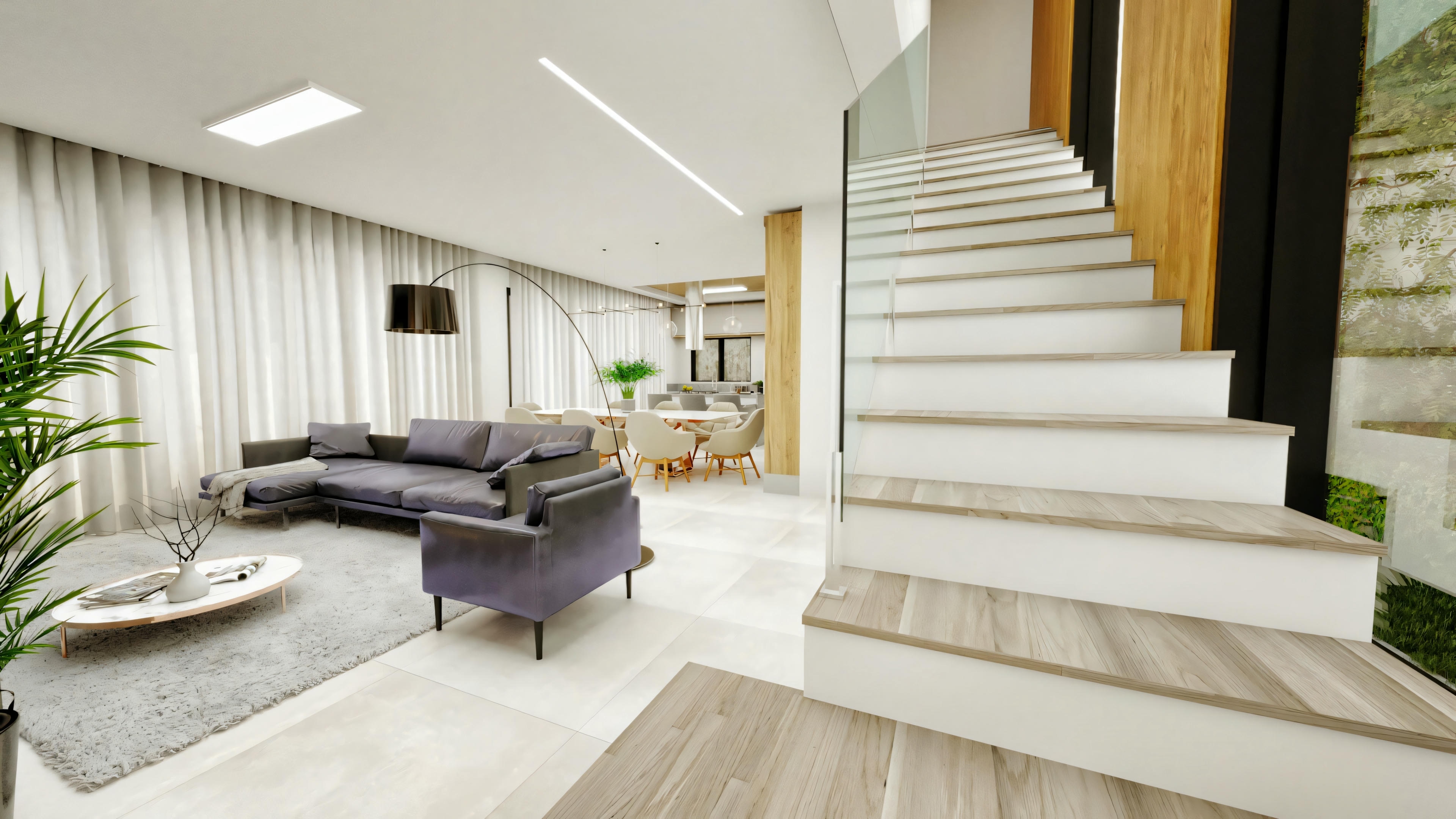Living room of a modern type 4 house, furnished with a gray L-shaped sofa, armchair, and rug, adjacent to a staircase with wood-clad steps and glass railing.
