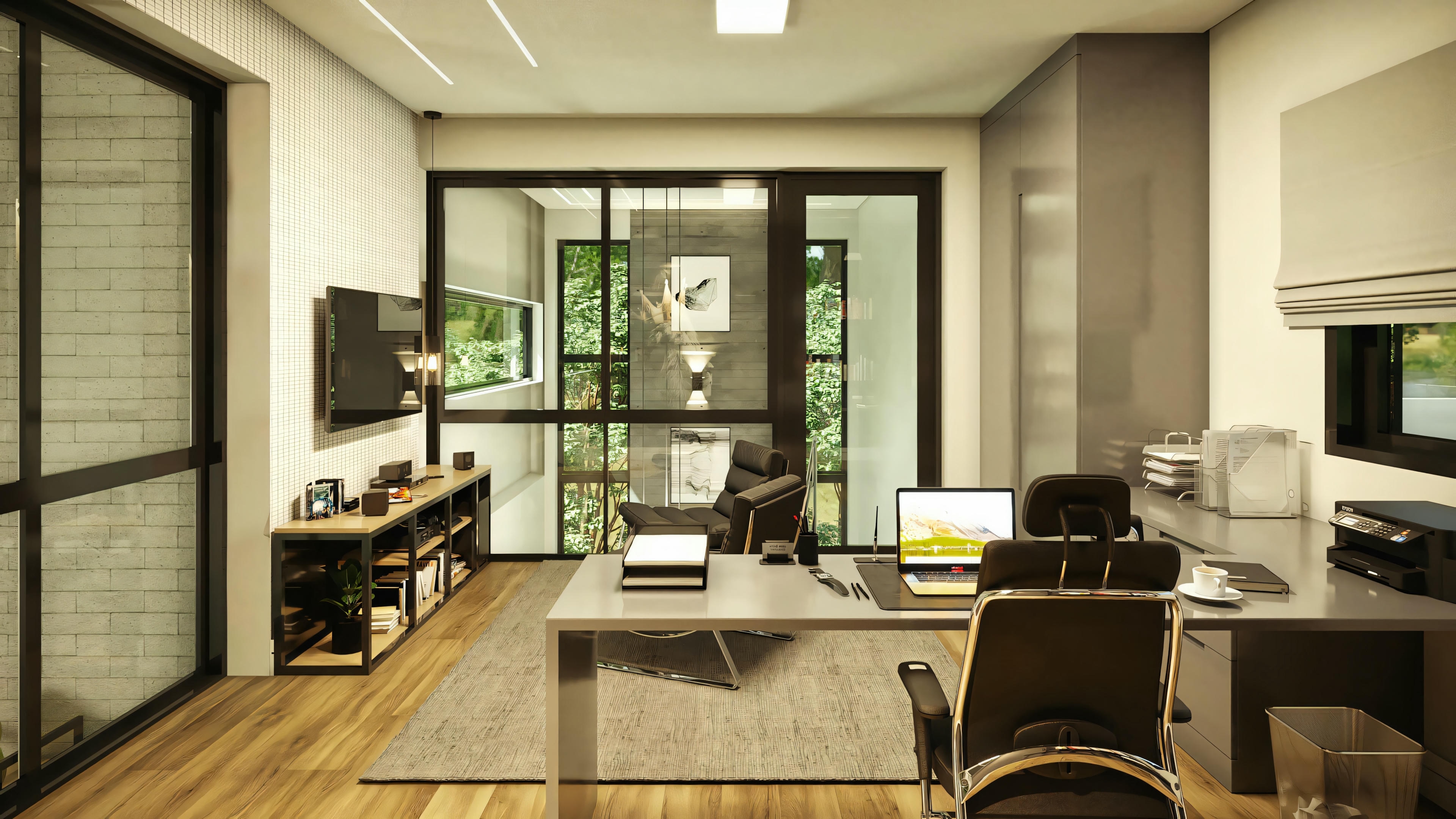 Modern home office with a desk, dual-monitor computer setup, and black office chair. There are shelves to the left and a small kitchen area in the background.