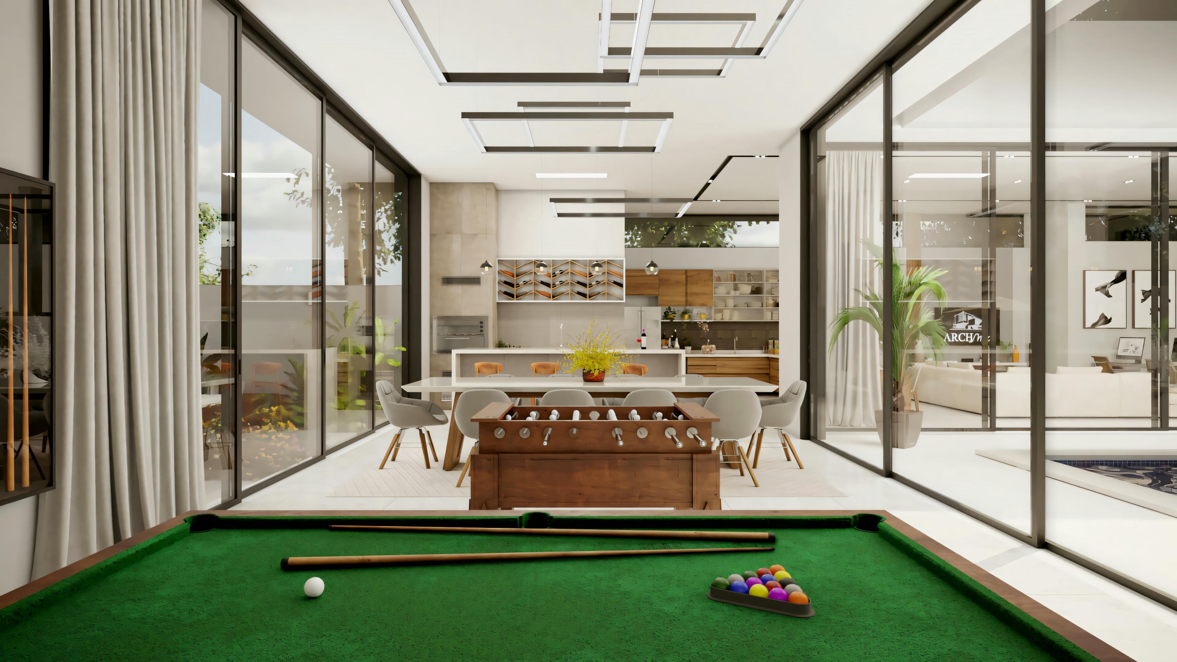Modern living room with billiard table, seating area, and kitchen in the background, with skylight ceiling.