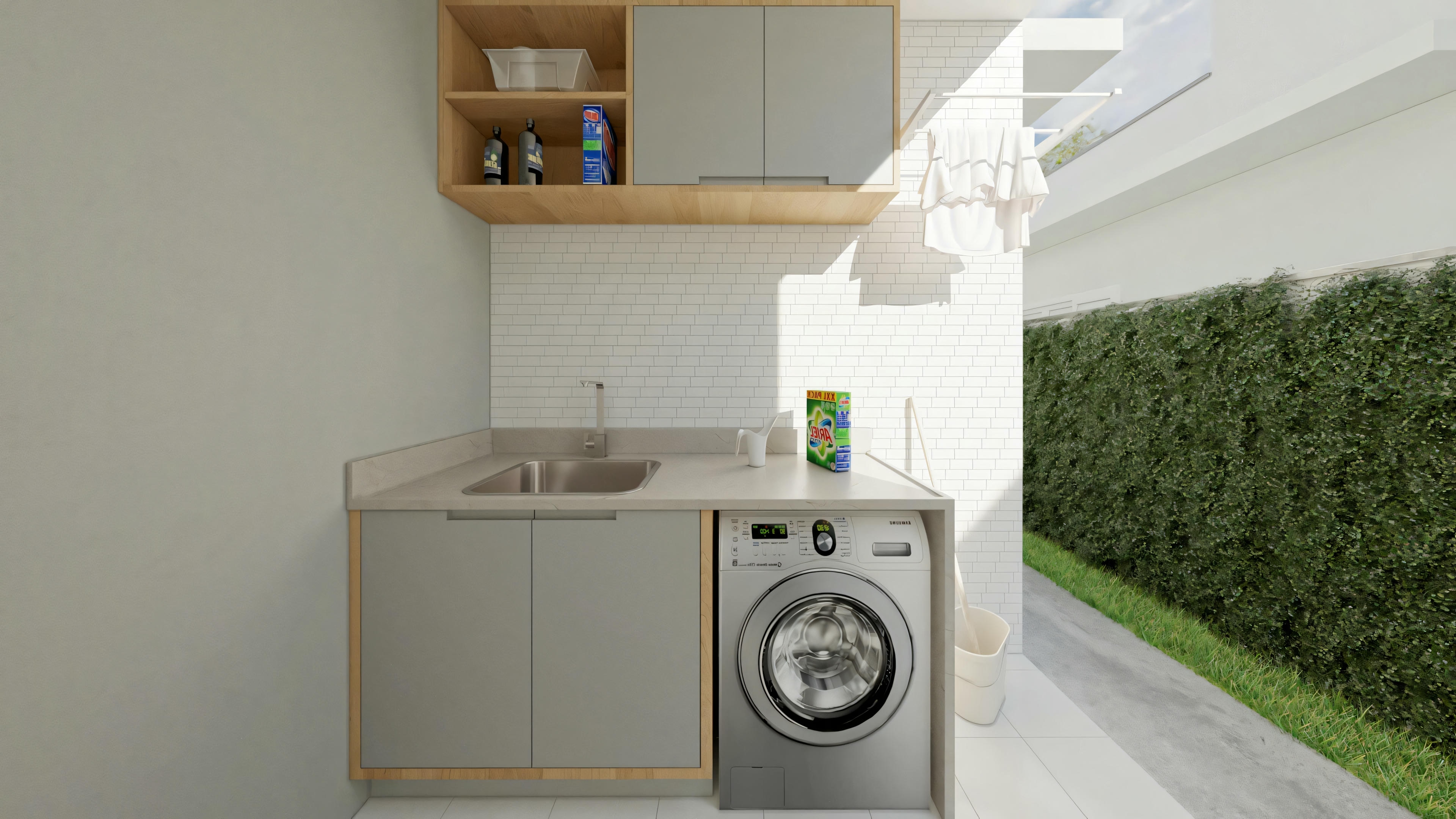 An outdoor laundry area with white walls, a washing machine, and built-in shelves above, with plants visible in the background.