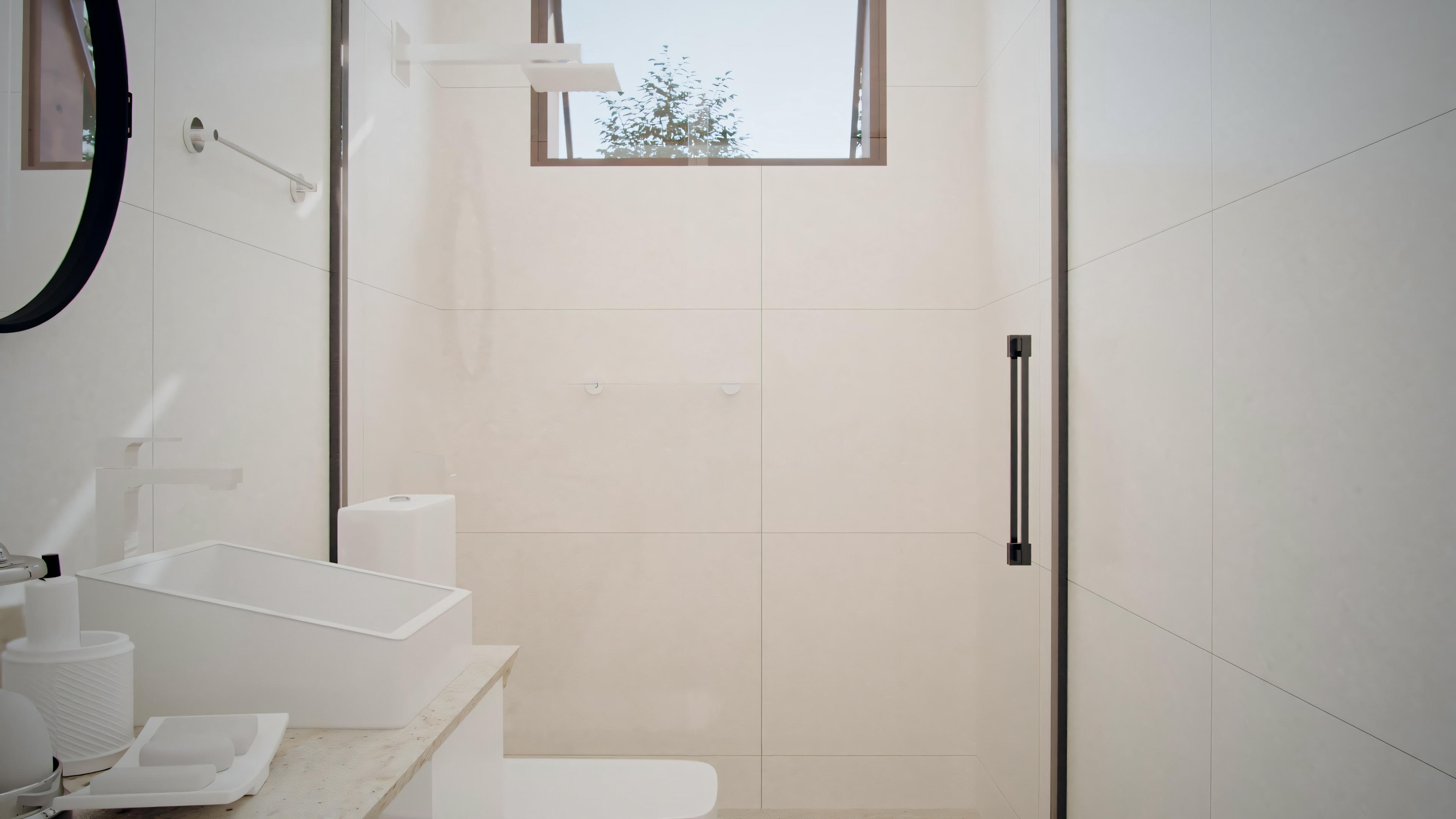A bathroom with white fixtures, including a sink and a shower area with glass doors.