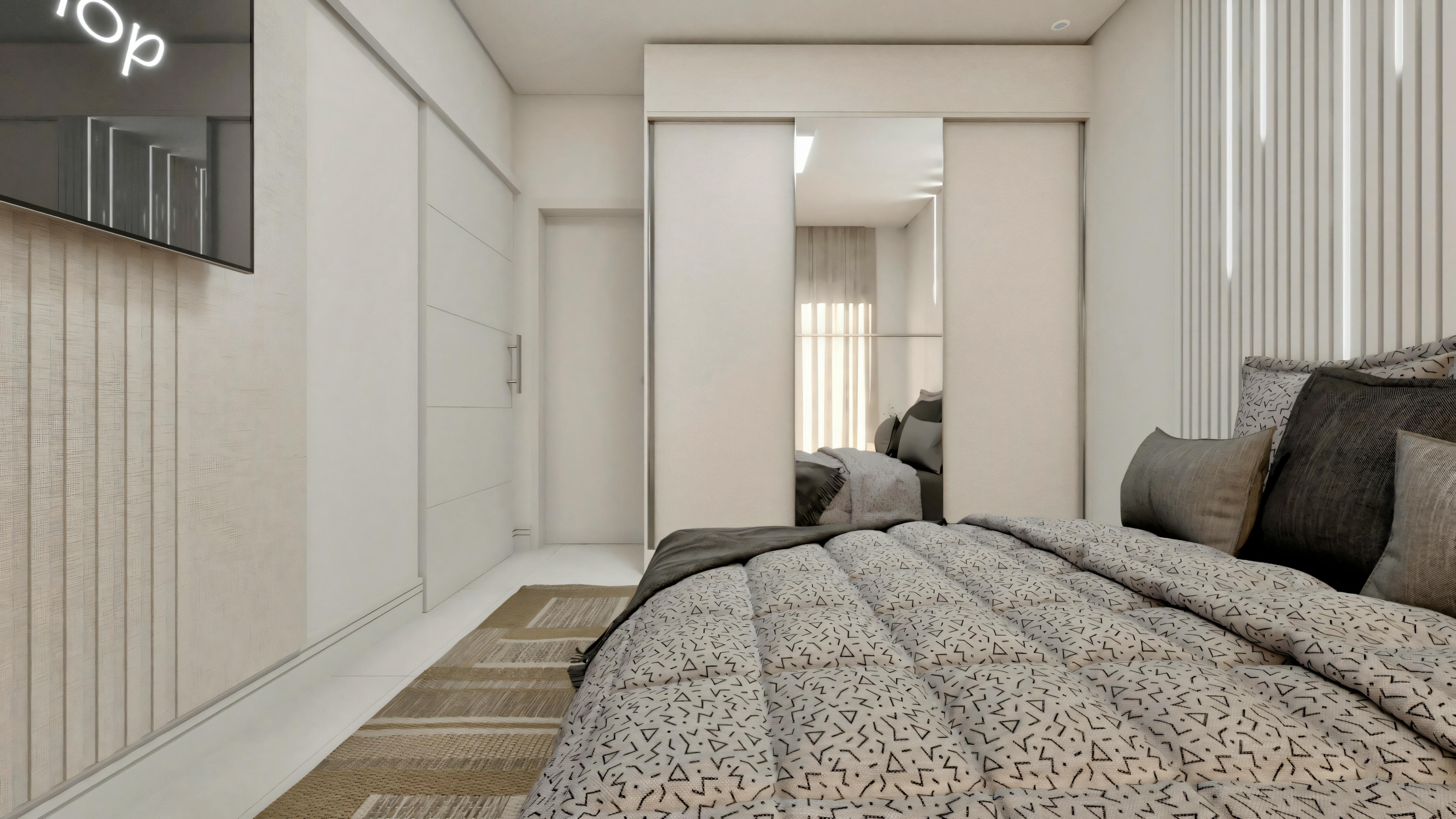 Bedroom with a textured quilt bed, nightstands with lamps, and a television mounted on the opposite wall.