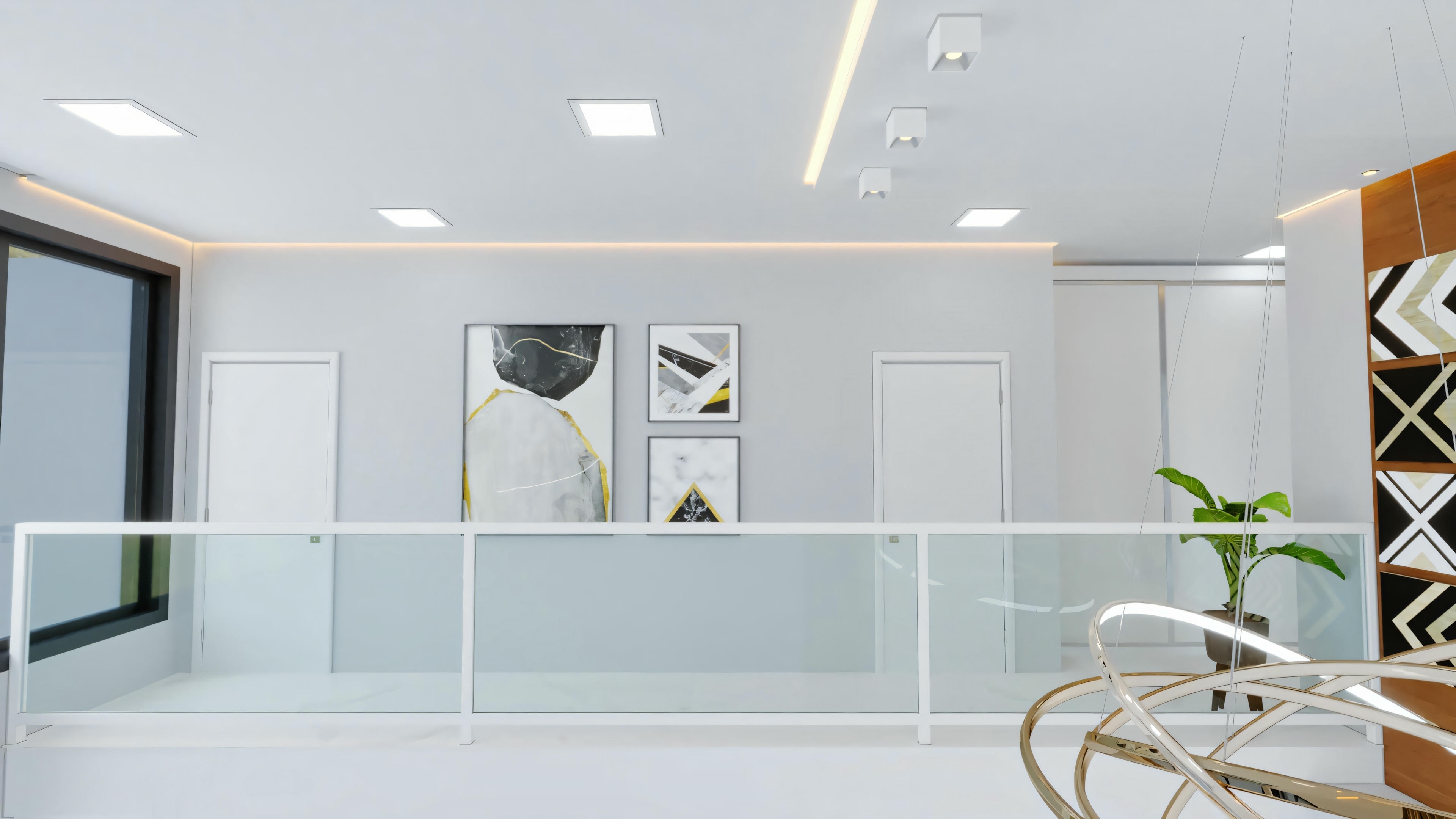 A modern interior space with a glass partition or railing, white ceiling with recessed lighting, walls adorned with framed pictures, and a bookshelf to the right.