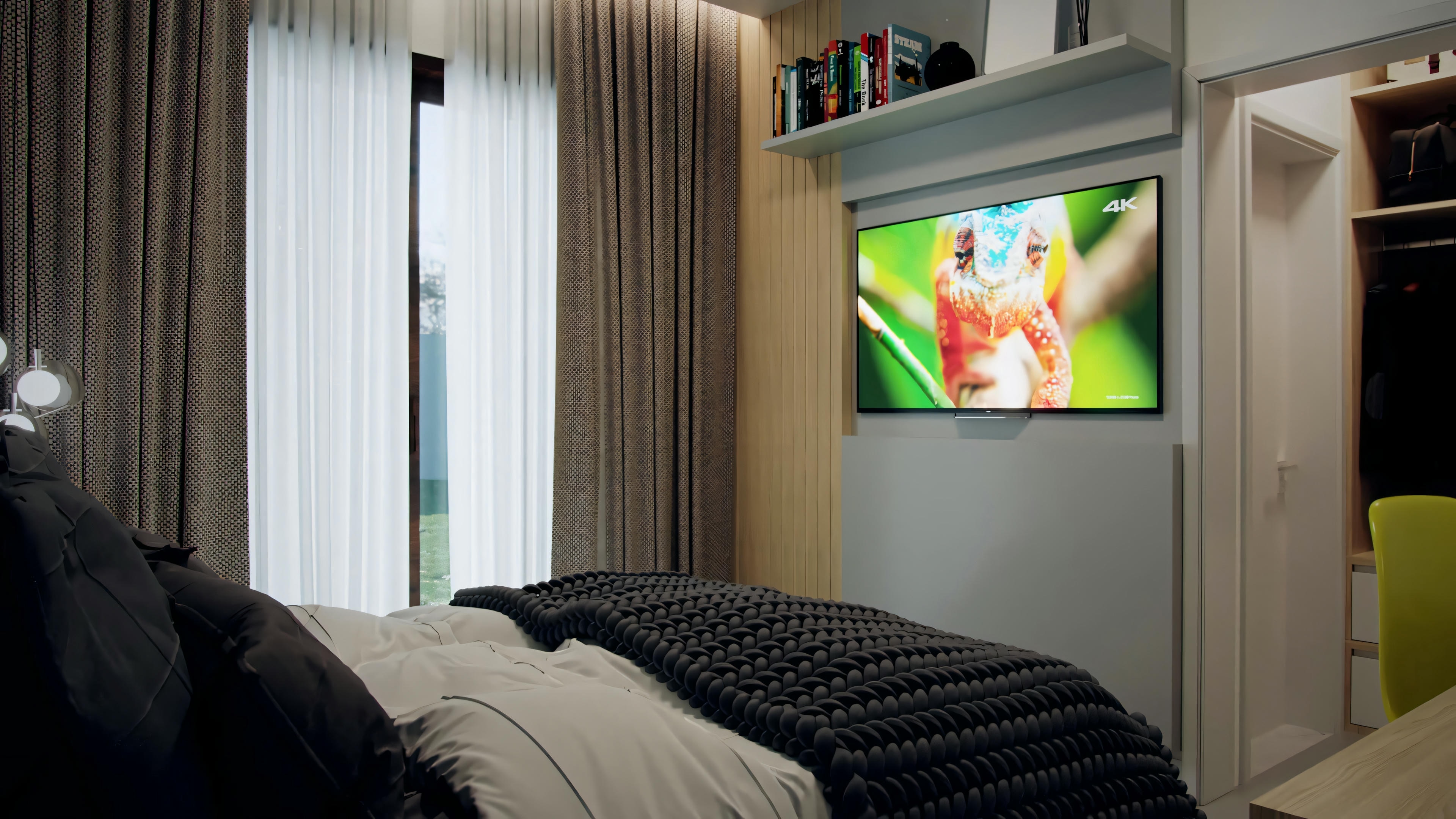 A bedroom with a large bed covered by a striped blanket, a nightstand, and a wall-mounted television displaying colorful graphics.