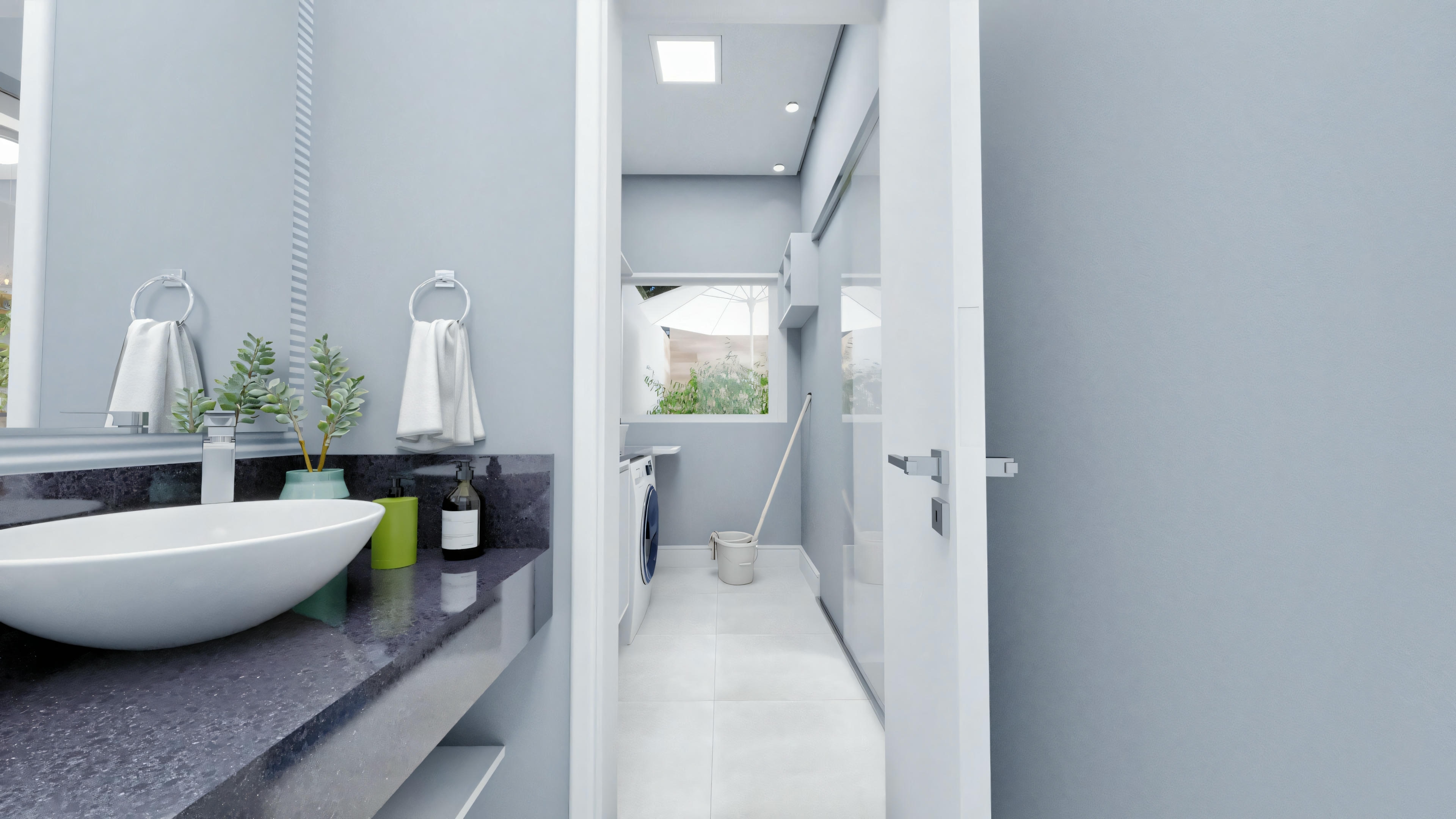 Bathroom with white walls, two sinks with mirrors above them, and towels hanging on the side. A toilet is visible in the background and there is a skylight providing natural light.
