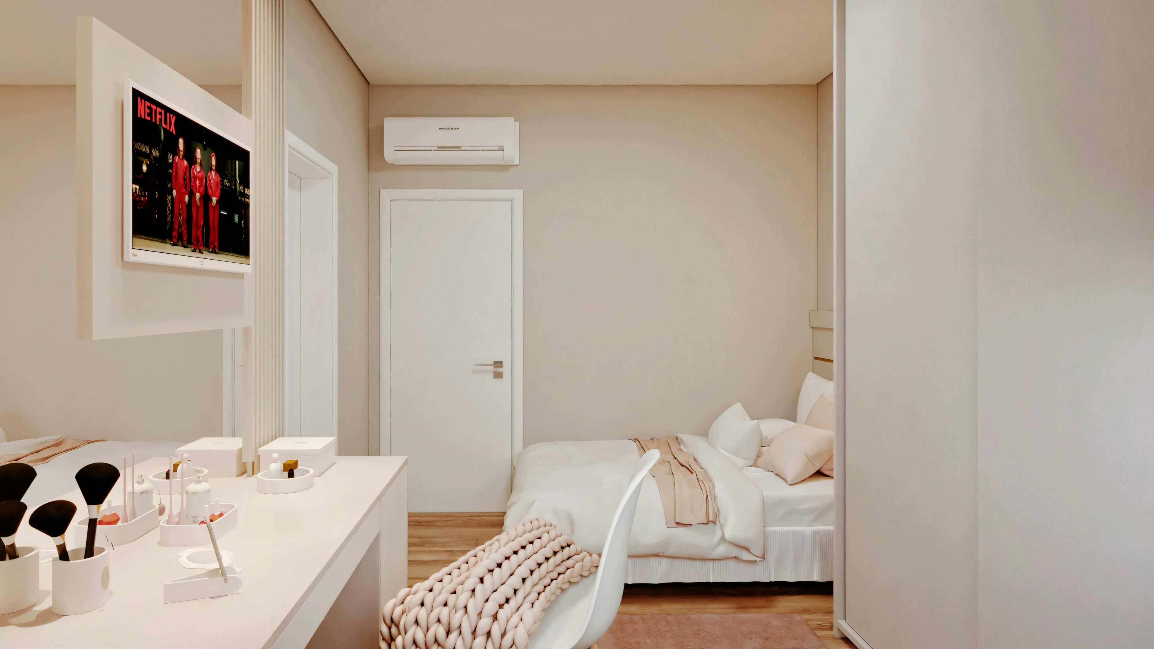 A small bedroom with white walls, a bed with white linens to the right, and a desk with a chair and computer to the left. A picture is hanging on the wall above the bed.
