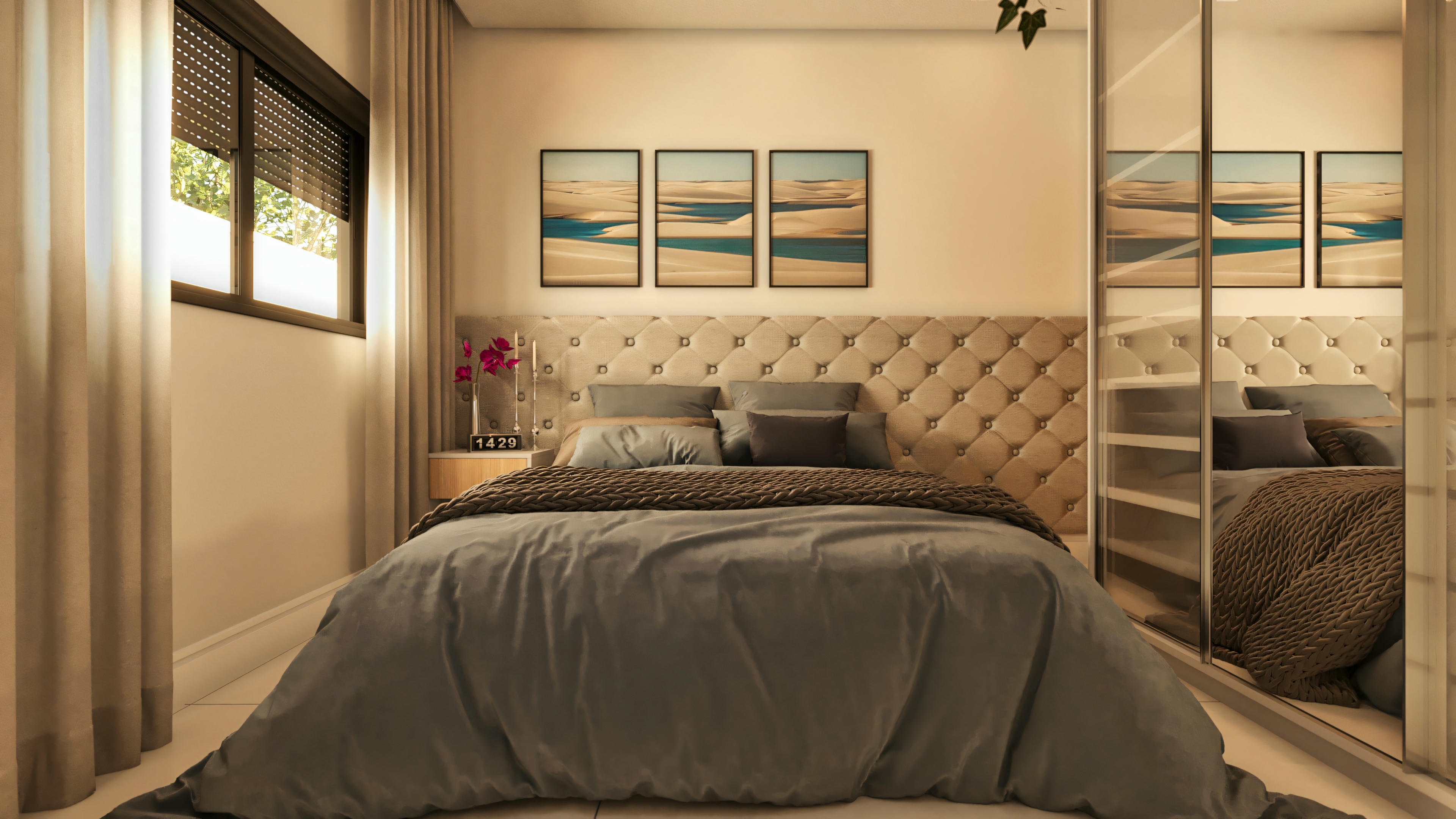 Master suite bedroom in a modern 3-bedroom house, featuring a bed with a gray tufted headboard, mirrored closet doors, window with blinds and curtains, and decorative paintings.
