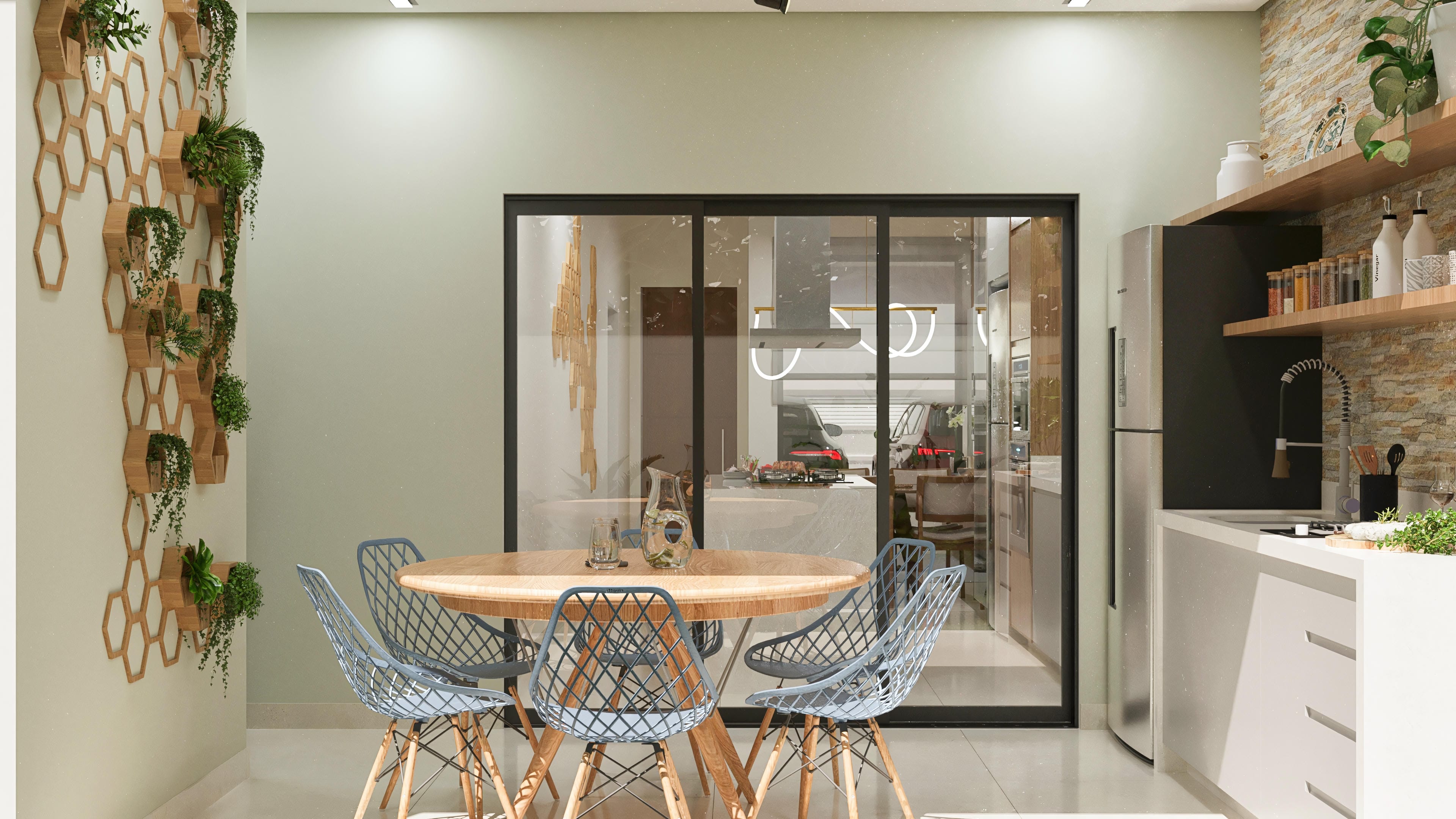 Modern dining room with a round table and mesh chairs, connected to a kitchen with an island and a gourmet area visible through large glass doors.