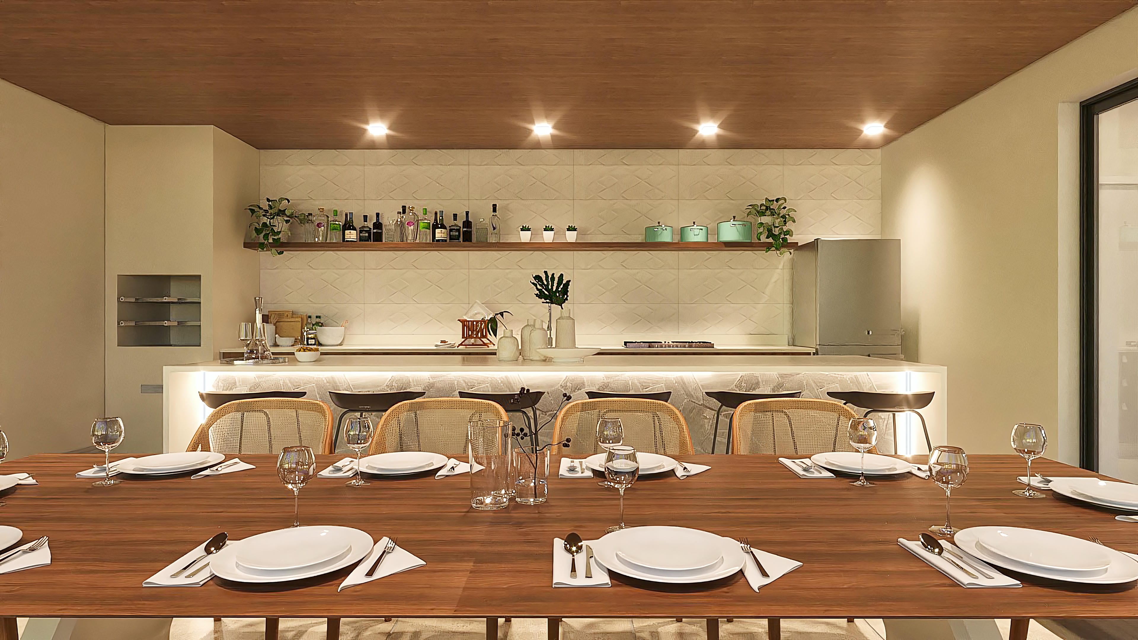 Integrated environment with dining table and gourmet kitchen. Wood details, textured tiles, and recessed lighting.