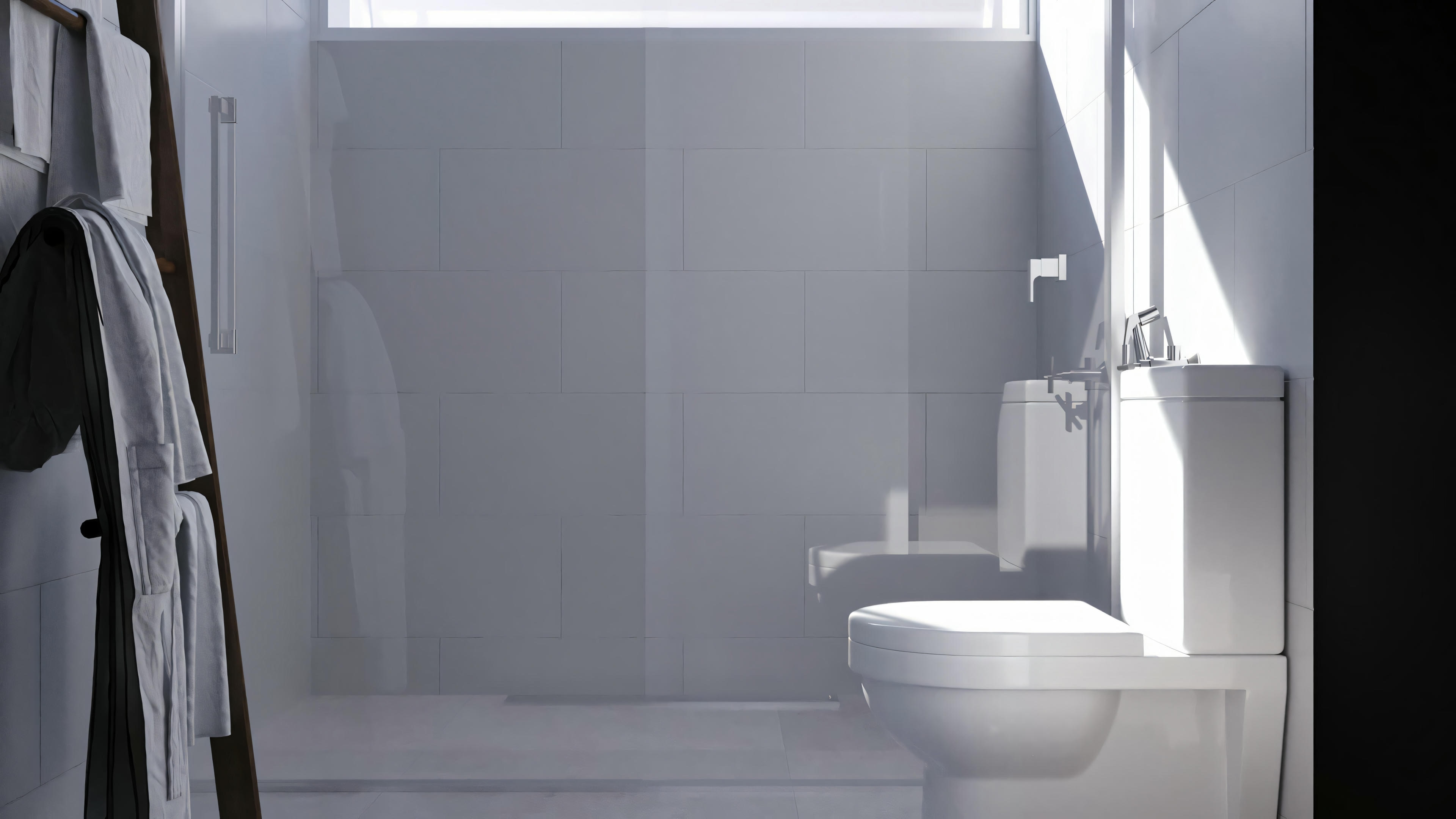A bathroom with a toilet and partially visible shower area, in gray tones.