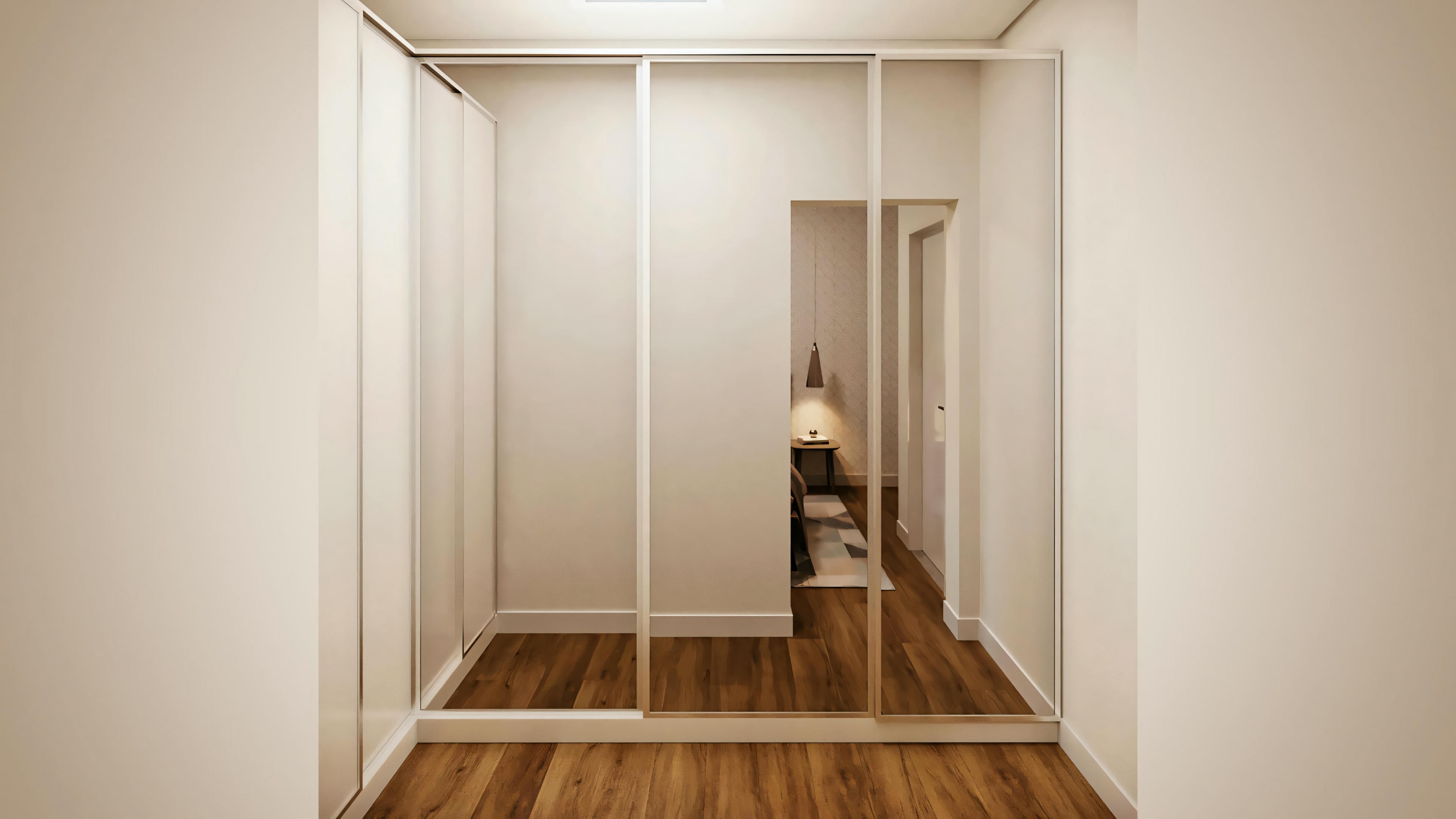 Interior view of a hallway with wooden floor, leading to a room where a person is partially visible.
