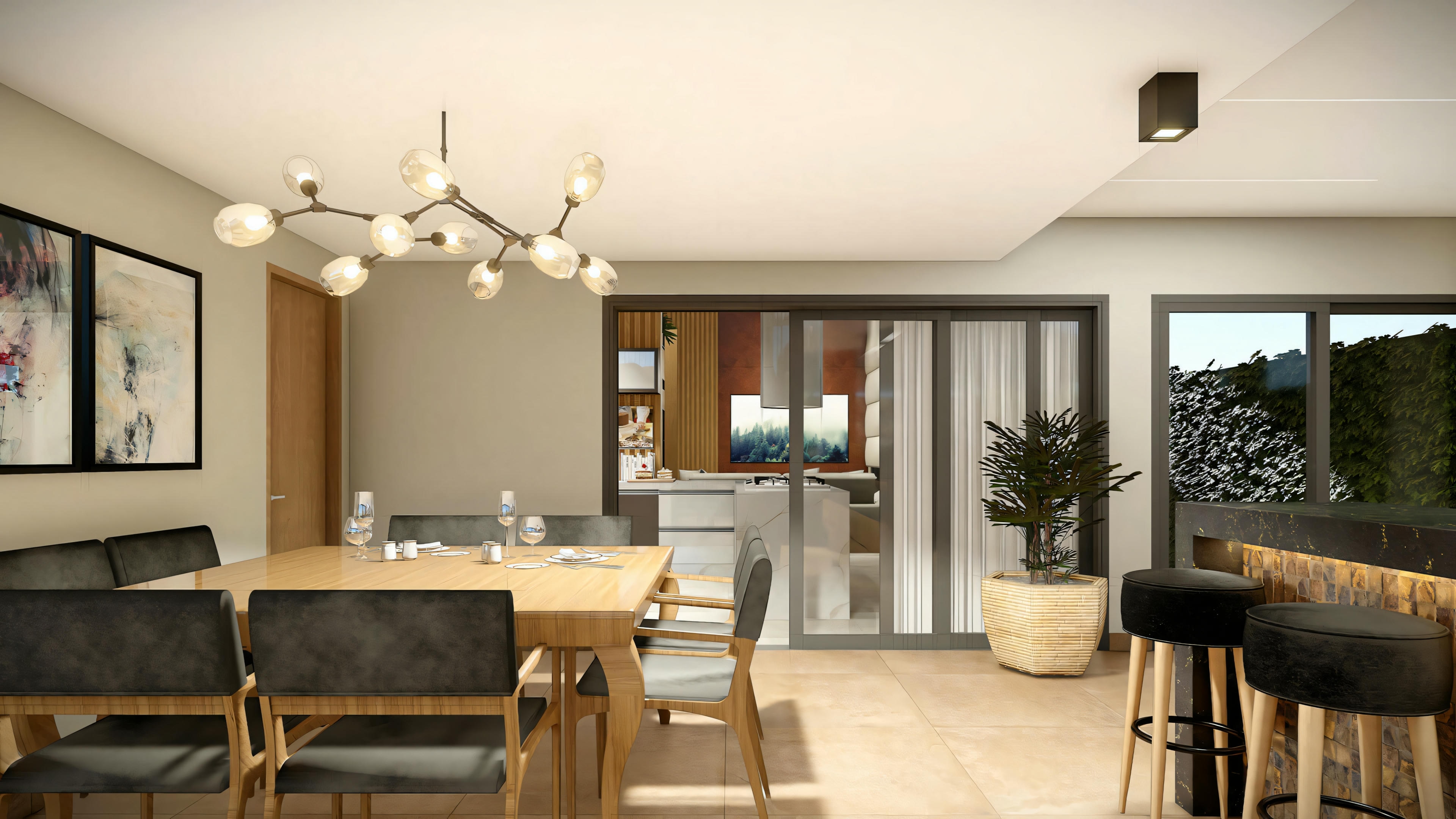 Un área de comedor con mesa para cuatro personas, lámparas modernas y cocina abierta con taburetes.